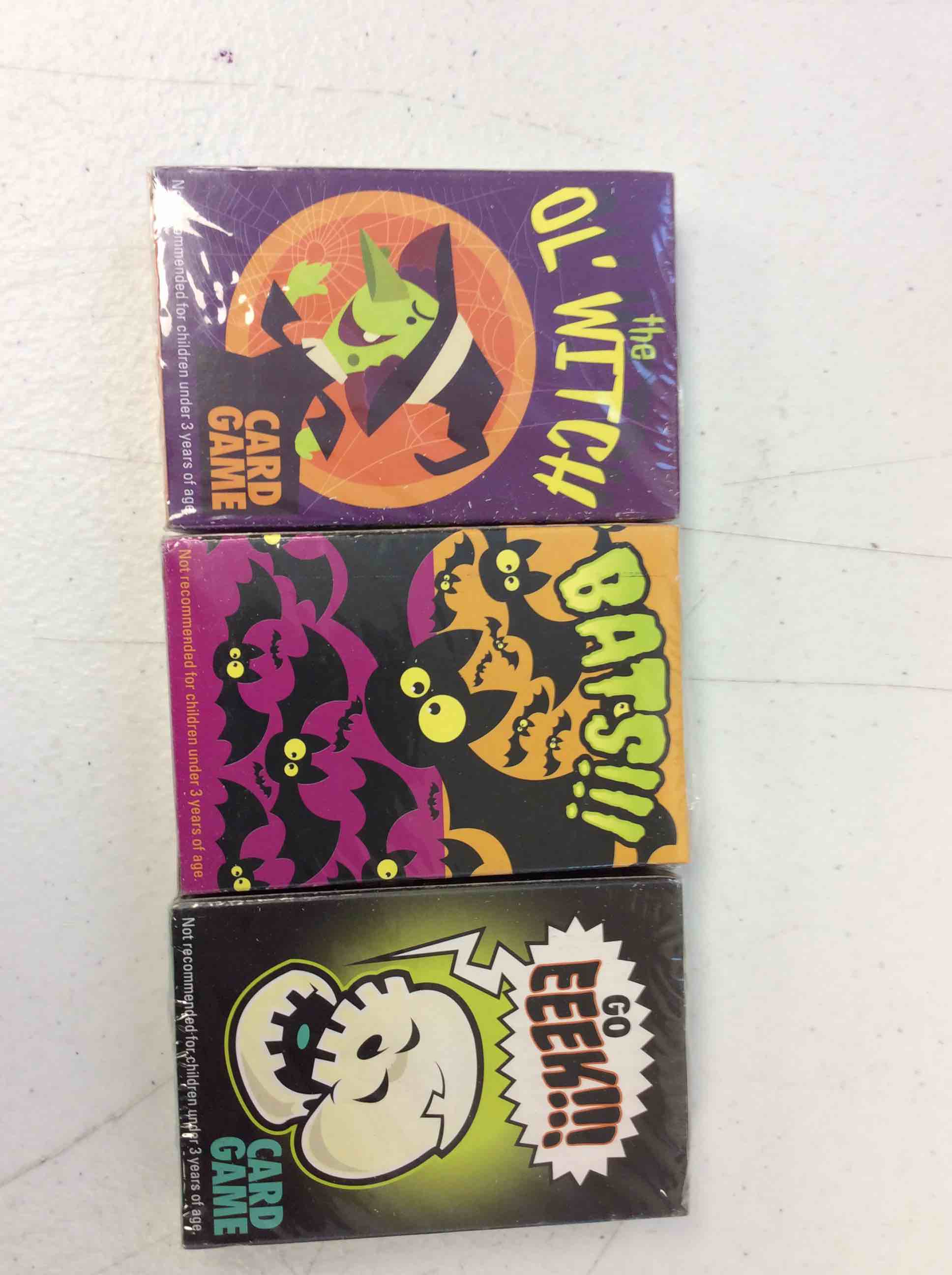 Condition photo showing New/Like New for three halloween themed card games