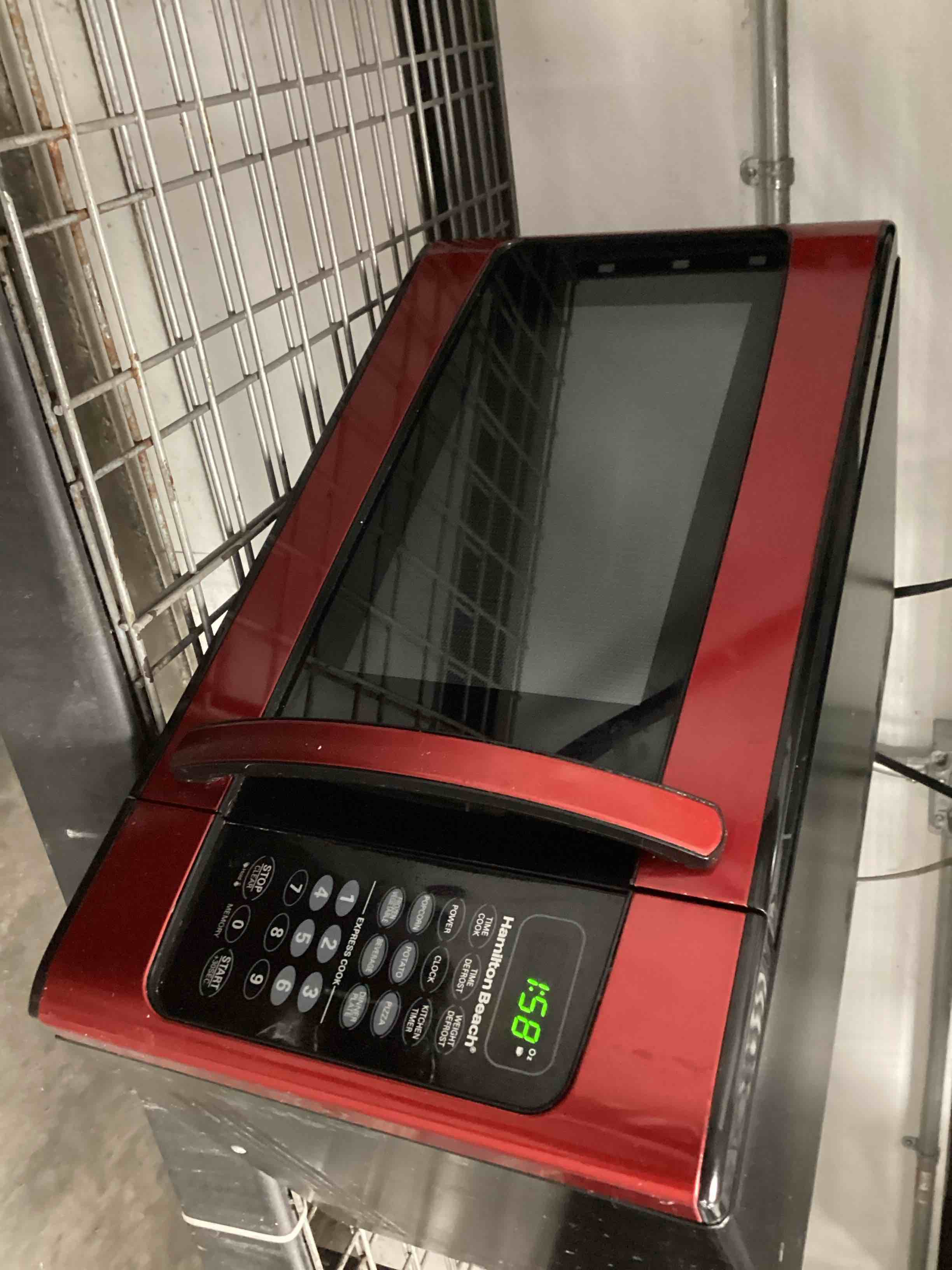 Condition photo showing As Is for Hamilton Beach 1.1 Cu. ft. Red Microwave