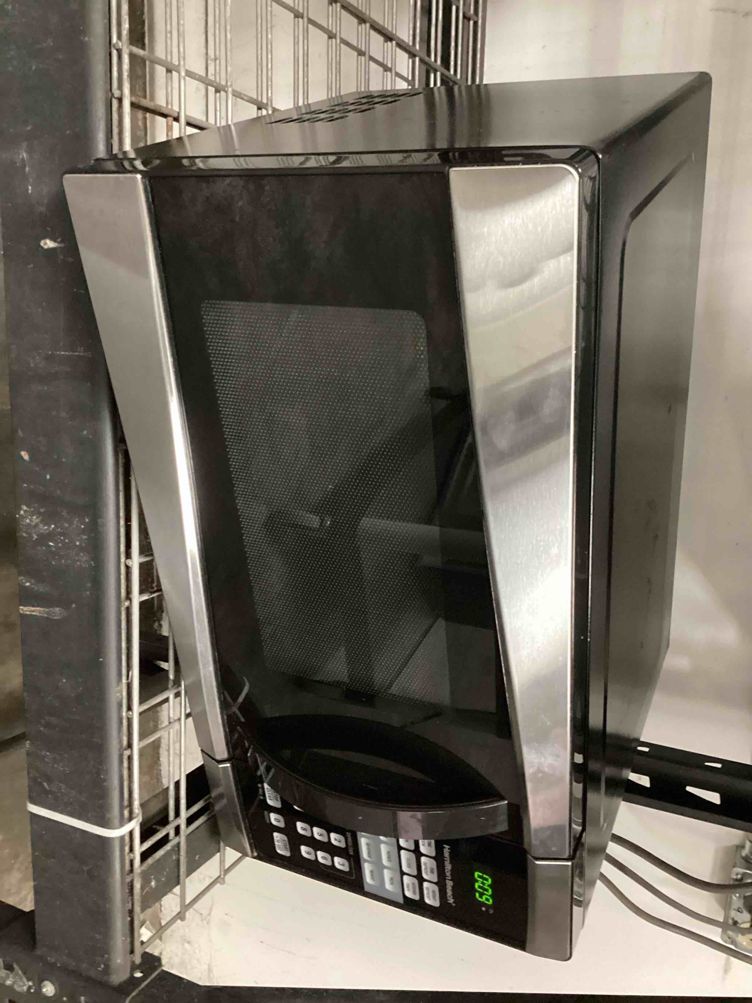 Condition photo showing As Is for Hamilton Beach 0.9 Cu. Ft. 900W Stainless Steel Microwave