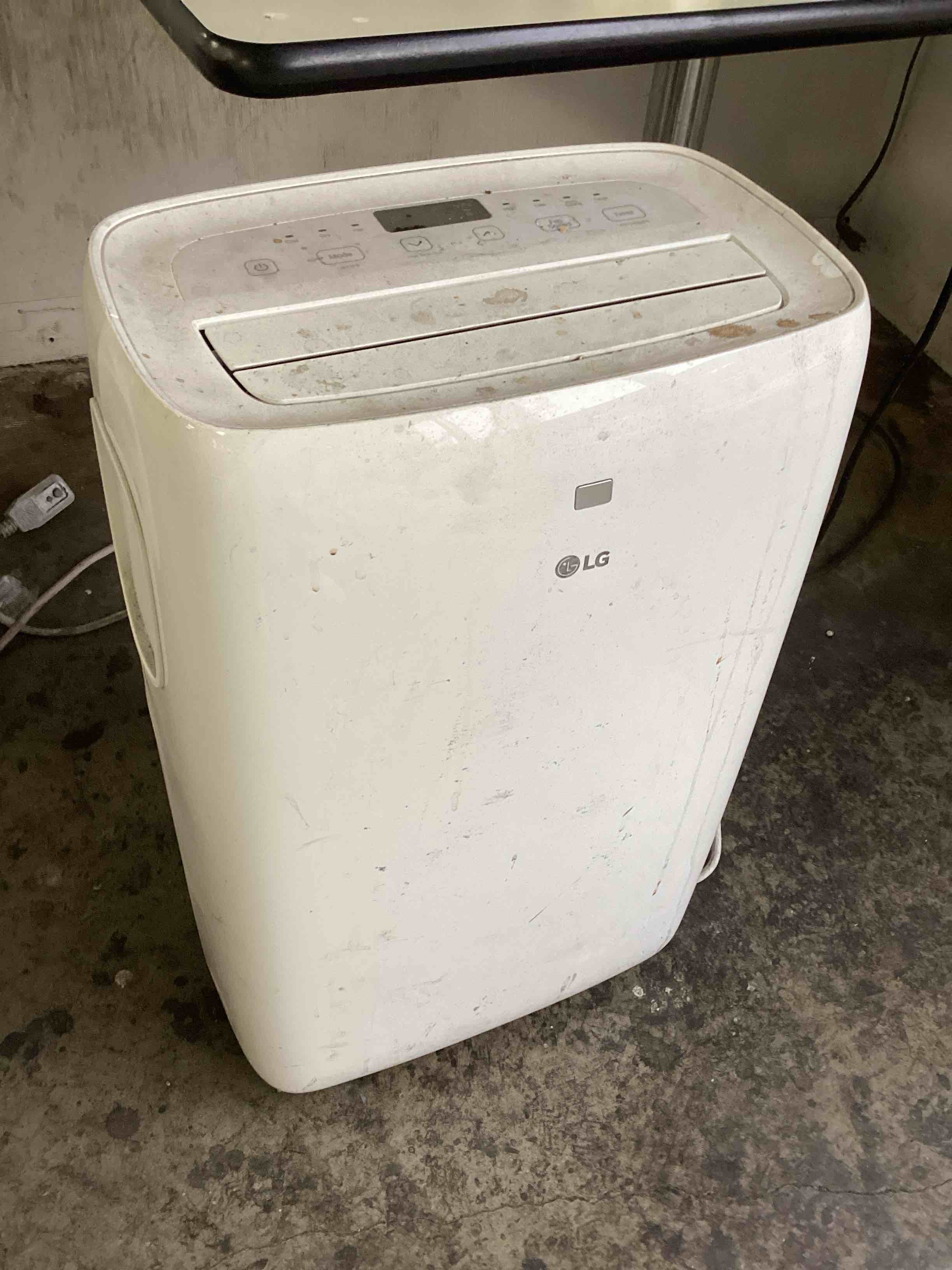 Condition photo showing As Is for LG 6,000 BTU Portable Air Conditioner, 115V, Cools 250 Sq.Ft. (10' x 25' Room Size), Portable Air Conditioner for Home with Quiet Operation, LCD Remote Control, and Window Installation Kit, White