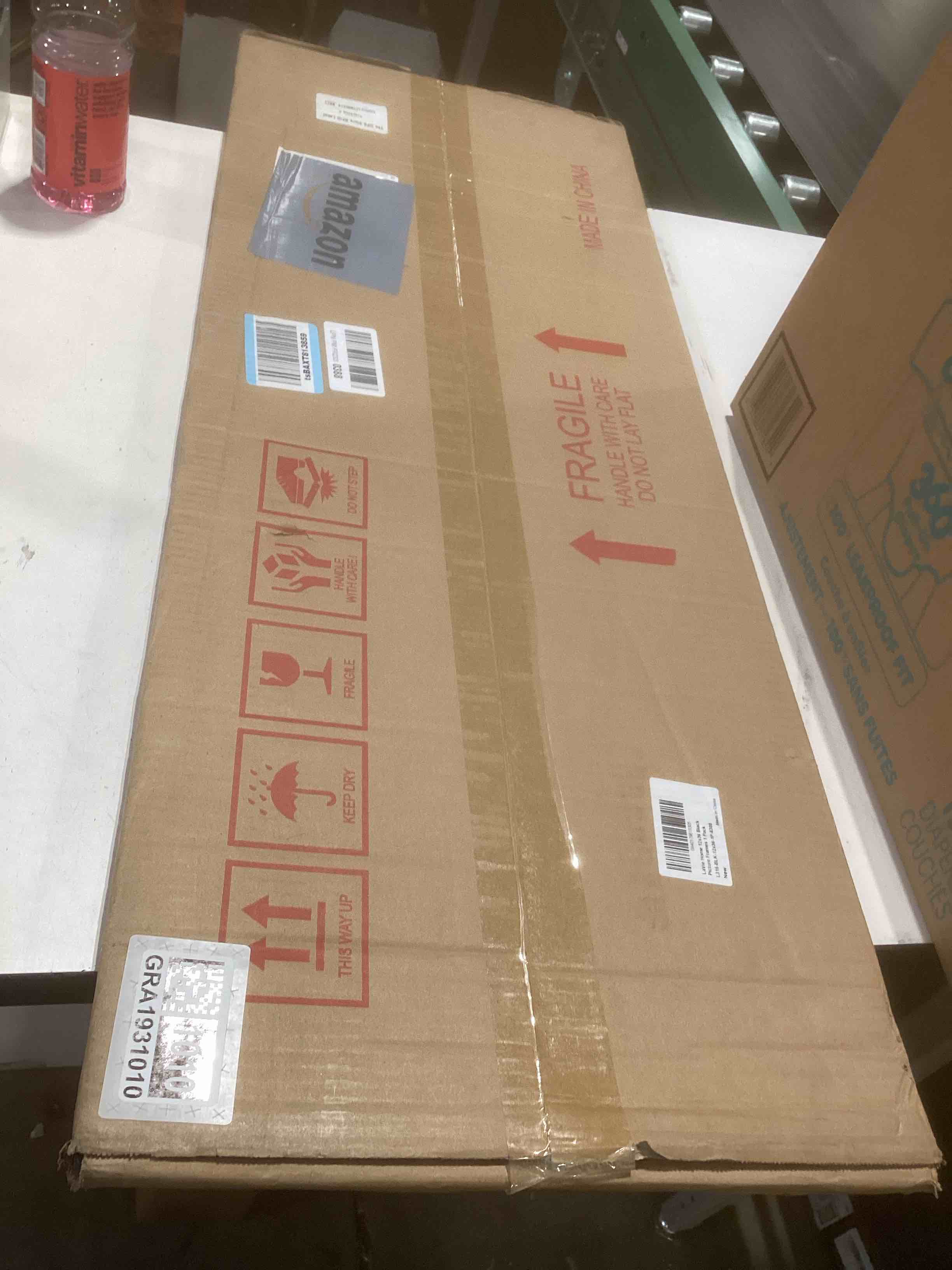 Condition photo showing As Is for Americanflat 12x36 Picture Frame with Polished Plexiglass - Streamline Collection - Thin Border Picture Frame for Wall Display - Hanging Hardware Included - Black Black 12x36