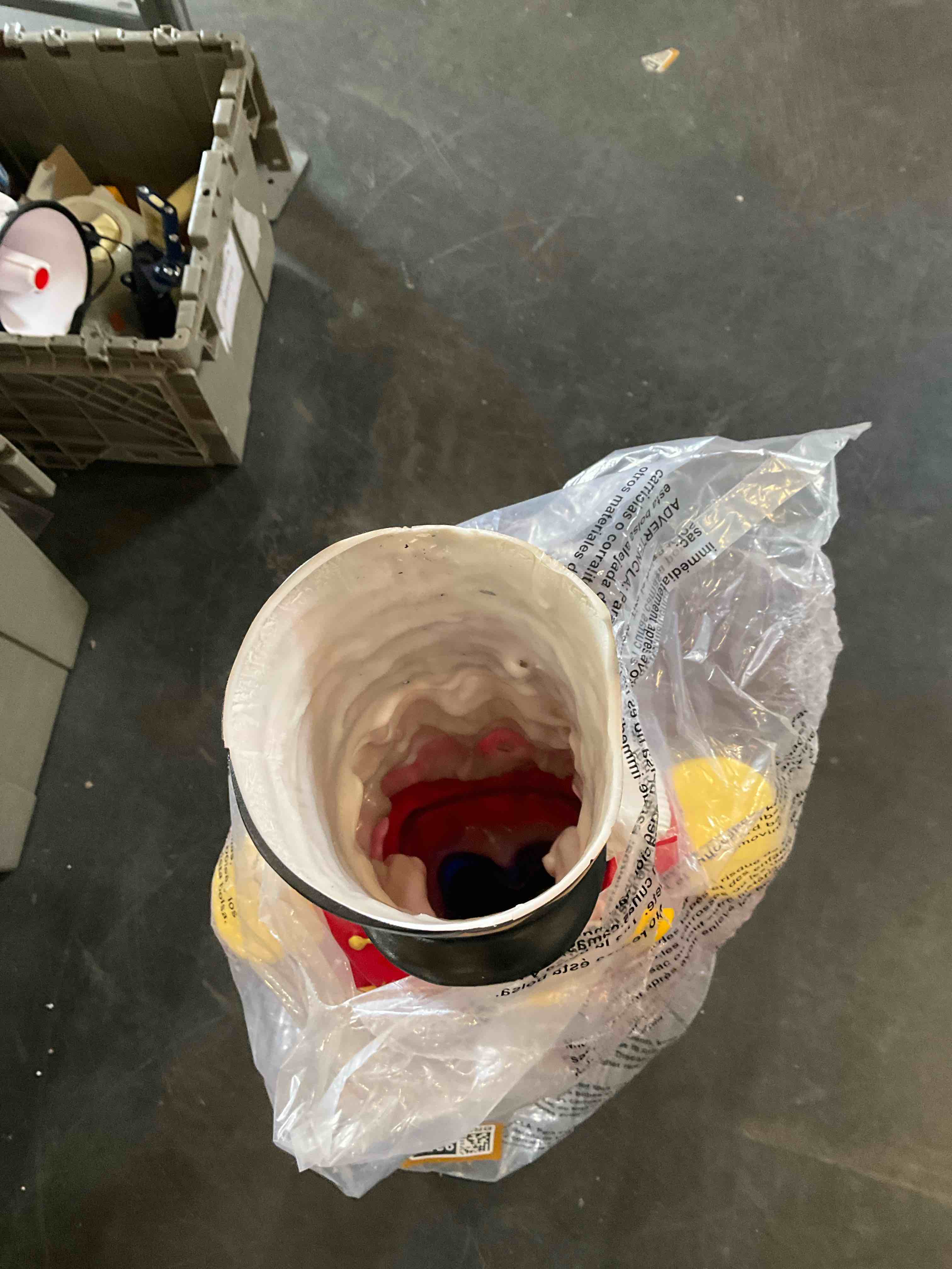 experimental. This image shows a large, plastic-wrapped Christmas nutcracker figure with a red jacket, blue pants, and a black and gold hat.