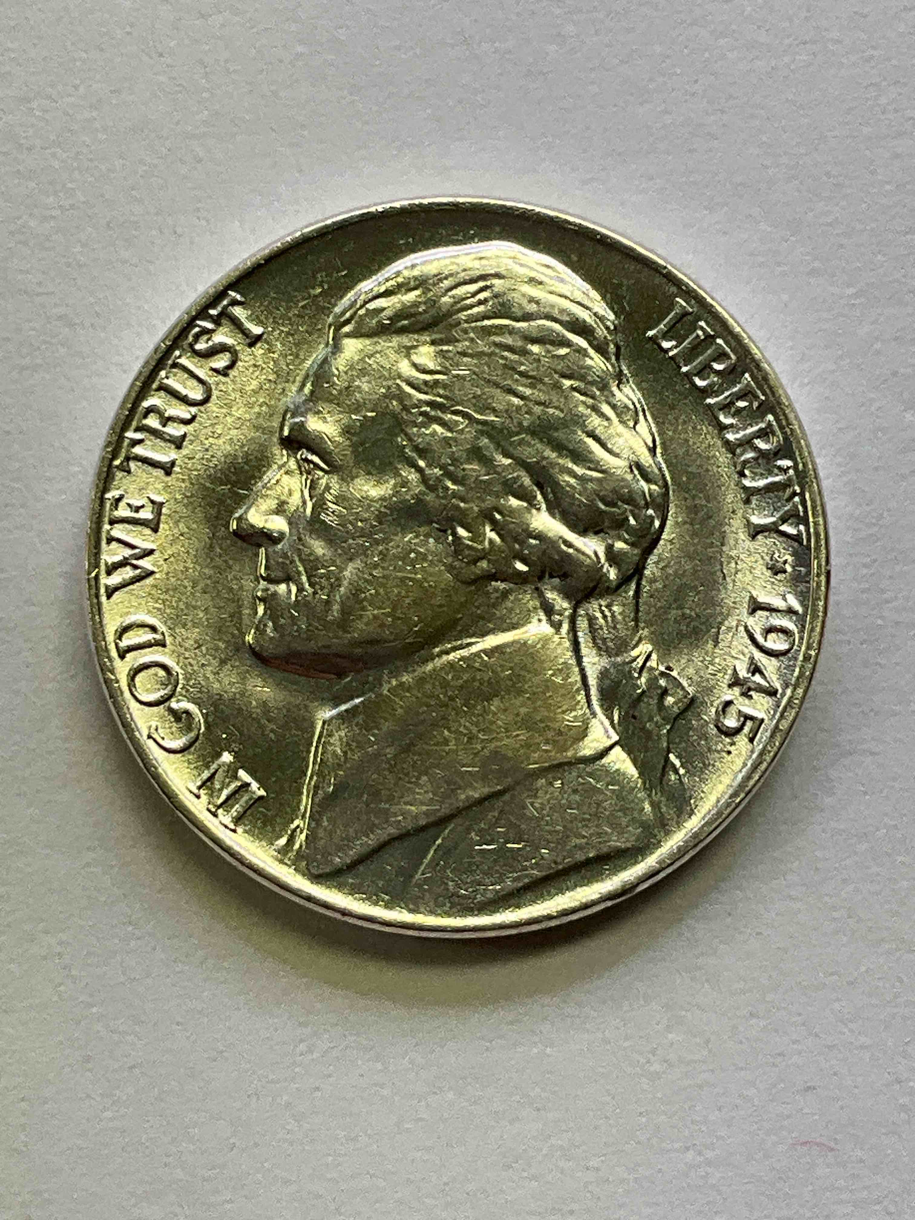 1945 World War II Uncirculated U.S. Silver! Did You Know That Nickels Were Actually Made Of Silver During World War II From 1942-45? This Is Because America Needed Nickel To Make Ammunition, So The U.S. Treasury Made Nickels Out Of Partial Silver Instead Of Nickel For These Three Years Only! Here Is An Awesome Example Of An Uncirculated, Pristine 1945 Silver Nickel! Own A Rare Piece Of Valuable World War II Precious Metal History! VERY Hard To Find!