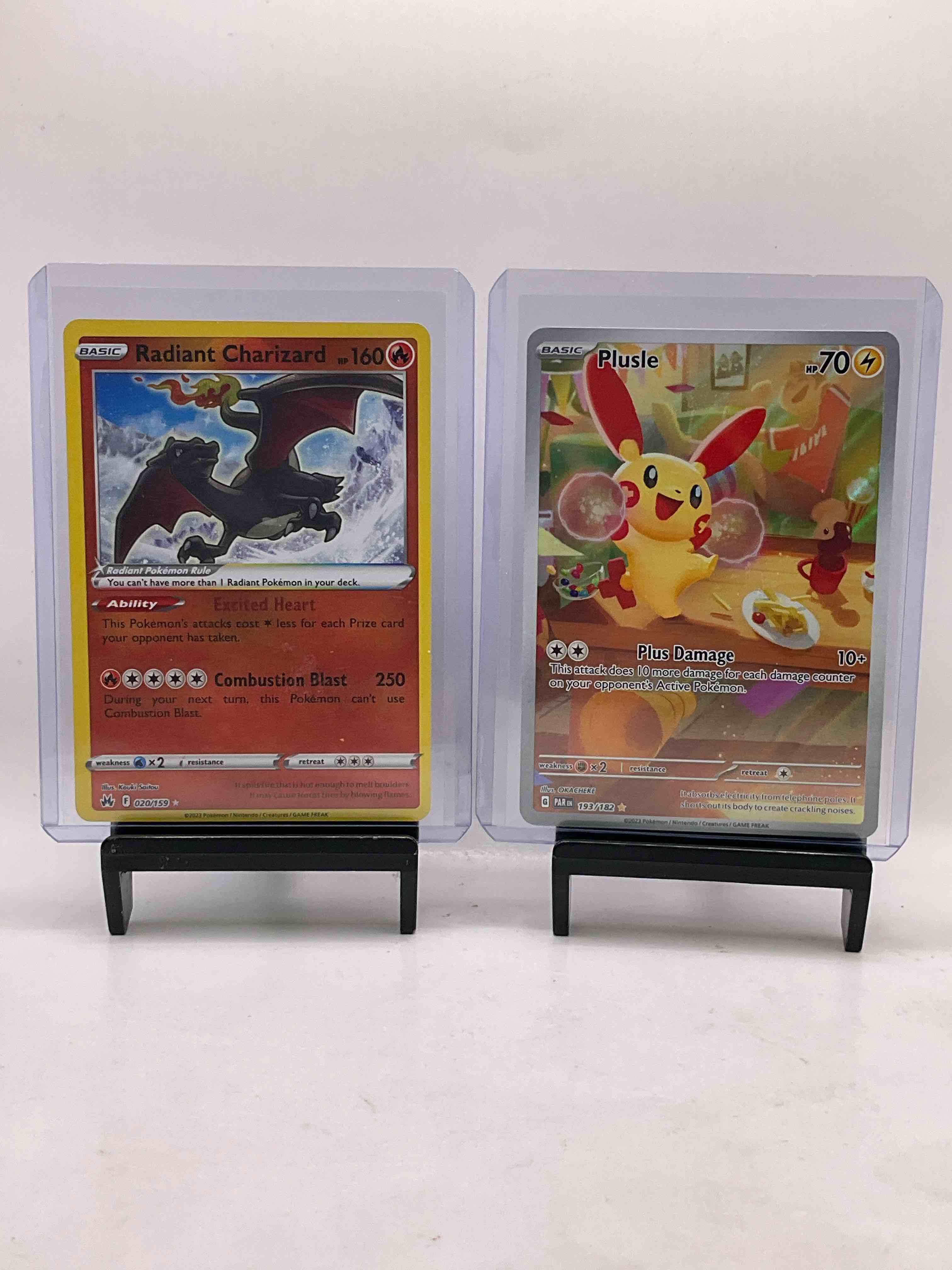 Pokémon Cards Galore! Check Out This Awesome Collection Of 50 Pokémon Cards, Includes Radiant Charizard Holofoil, Plusle Plus Damage & Many Other Awesome Cards Including Many Holofoils! Get Into The Craze!