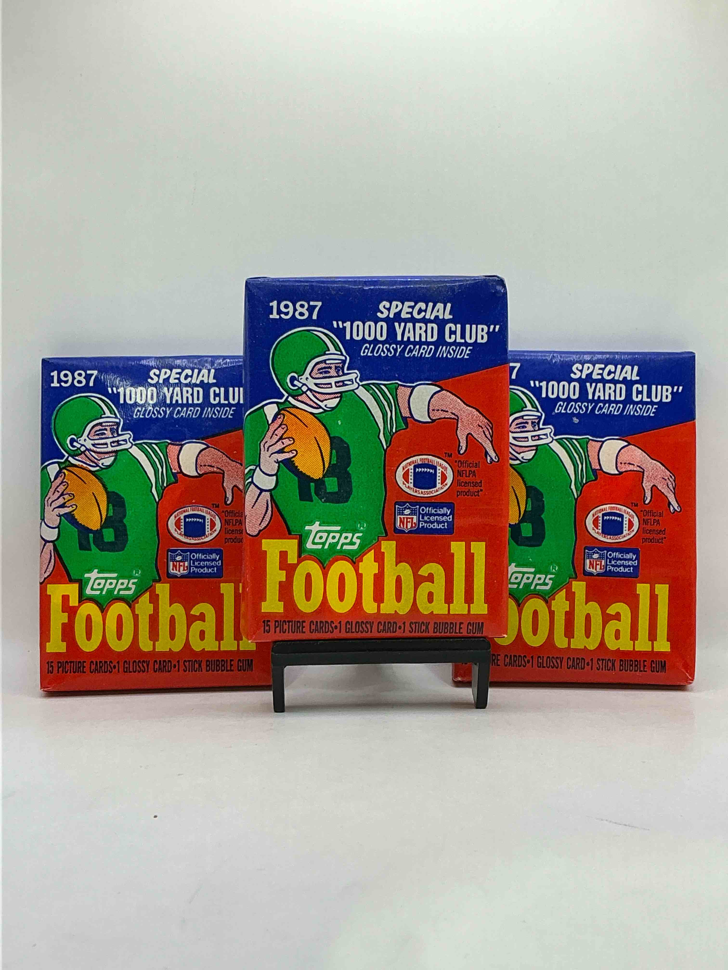 1987 Topps Football! Yes! Unopened 1987 Topps Football Card Wax Pack, Direct From A Warehouse Find Where It Has Been Stored For Decades! 1987 Is An Epic Year For Topps Football With Valuable Rookies Galore! Search For Randall Cunningham Rookie #296 (PSA 10 Est Value $900), Jim Kelly Rookie #362 (PSA 10 Est Value $475), Jerry Rice #115 (PSA 10 Est Value $450), Herschel Walker Rookie #264 (PSA 10 Est Value $400), Larwence Taylor, Joe Montana... Too Many Potential Awesome Cards To List! Potential Condition / PSA Rating Of Cards Is Not Guaranteed Or Implied. 1987 Topps Football Is A Great Candidate For Investment!