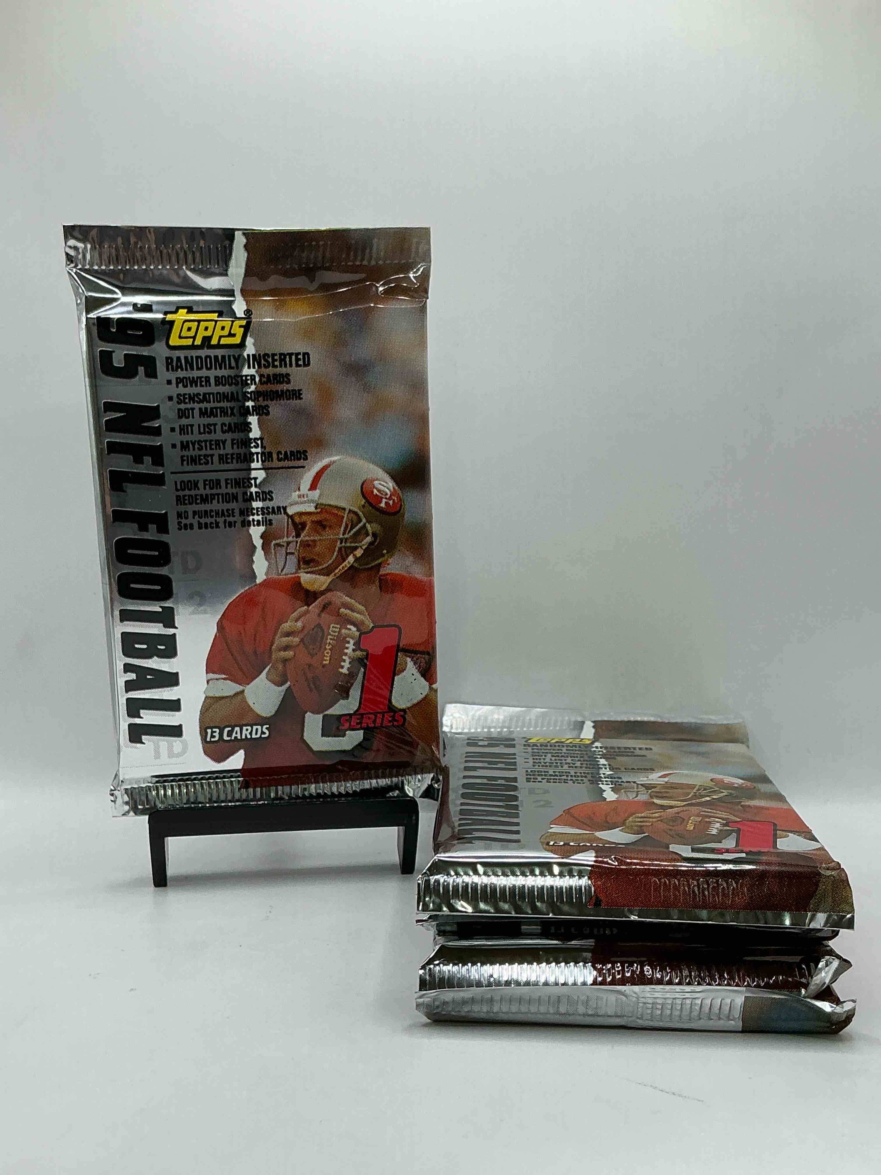 1995 NFL Football! Topps Series 1 NFL Football… 13 Cards Per Pack! Look For Legends, Rookies & More! Also Look For Randomly Inserted Power Booster, Sensational Sophomore, Hit List Cards & More! 90’s Football!