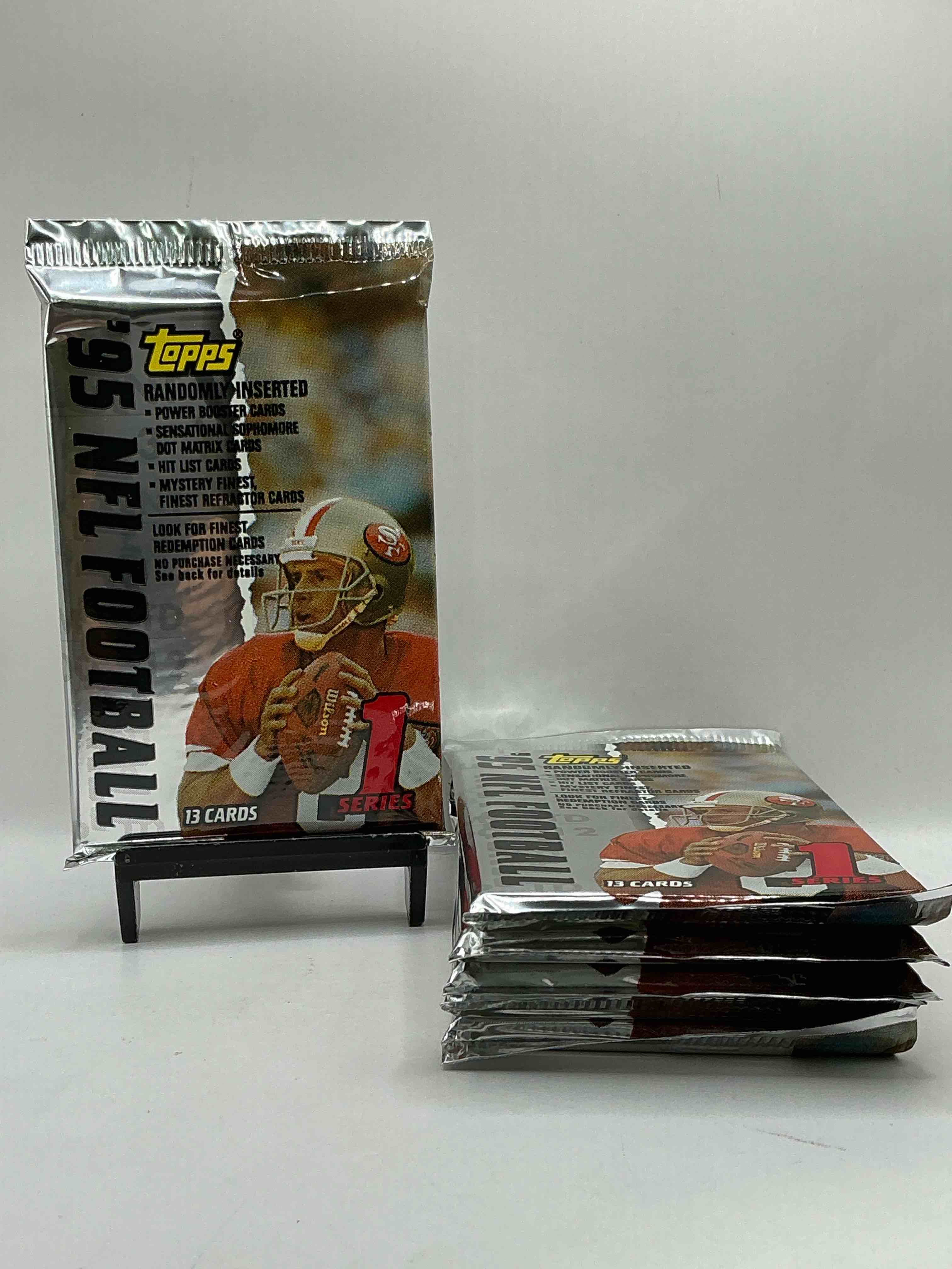 1995 NFL Football! Topps Series 1 NFL Football… 13 Cards Per Pack! Look For Legends, Rookies & More! Also Look For Randomly Inserted Power Booster, Sensational Sophomore, Hit List Cards & More! 90’s Football!