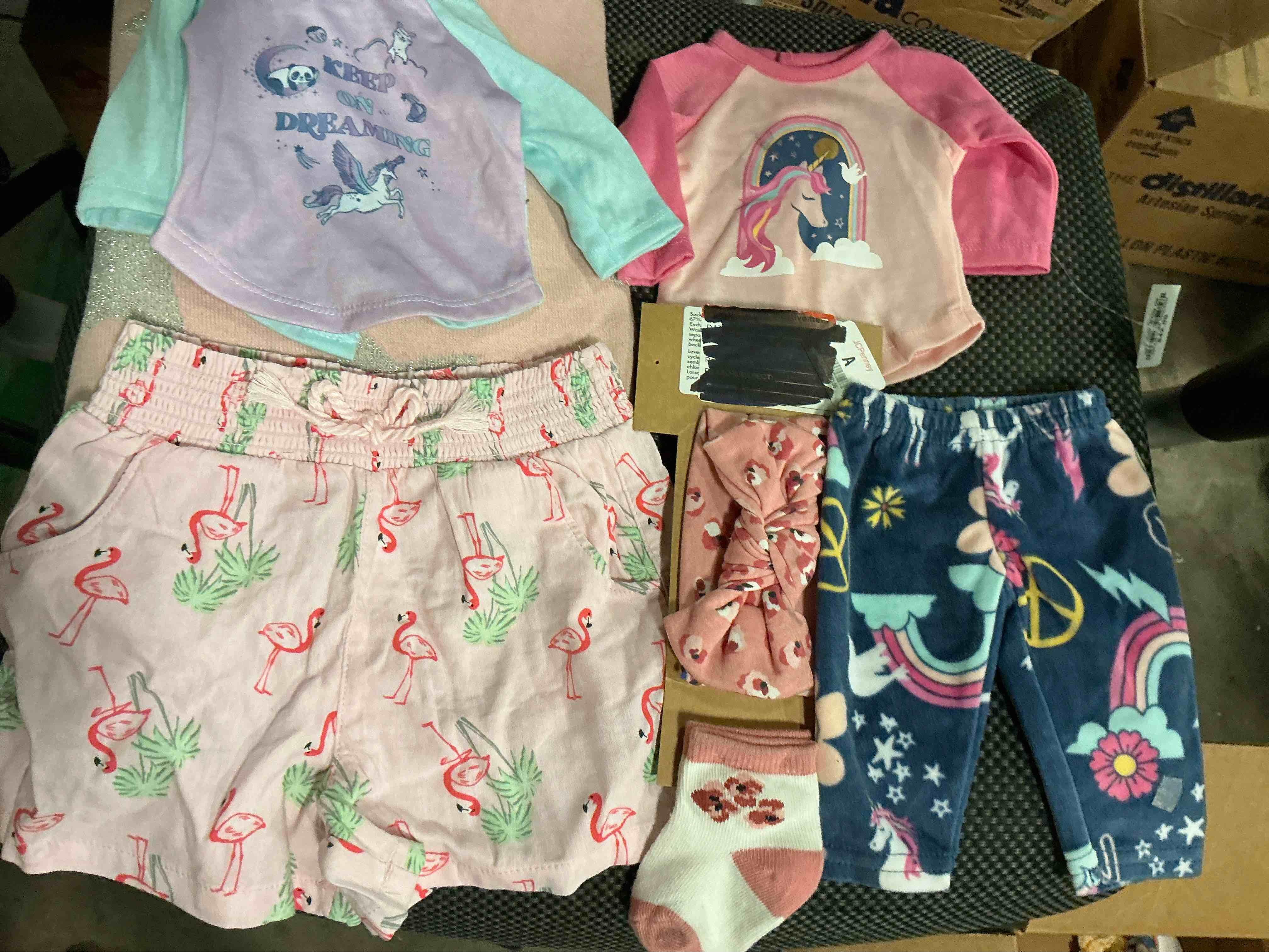 Assortment of doll clothes of different styles and sizes (20 pieces)