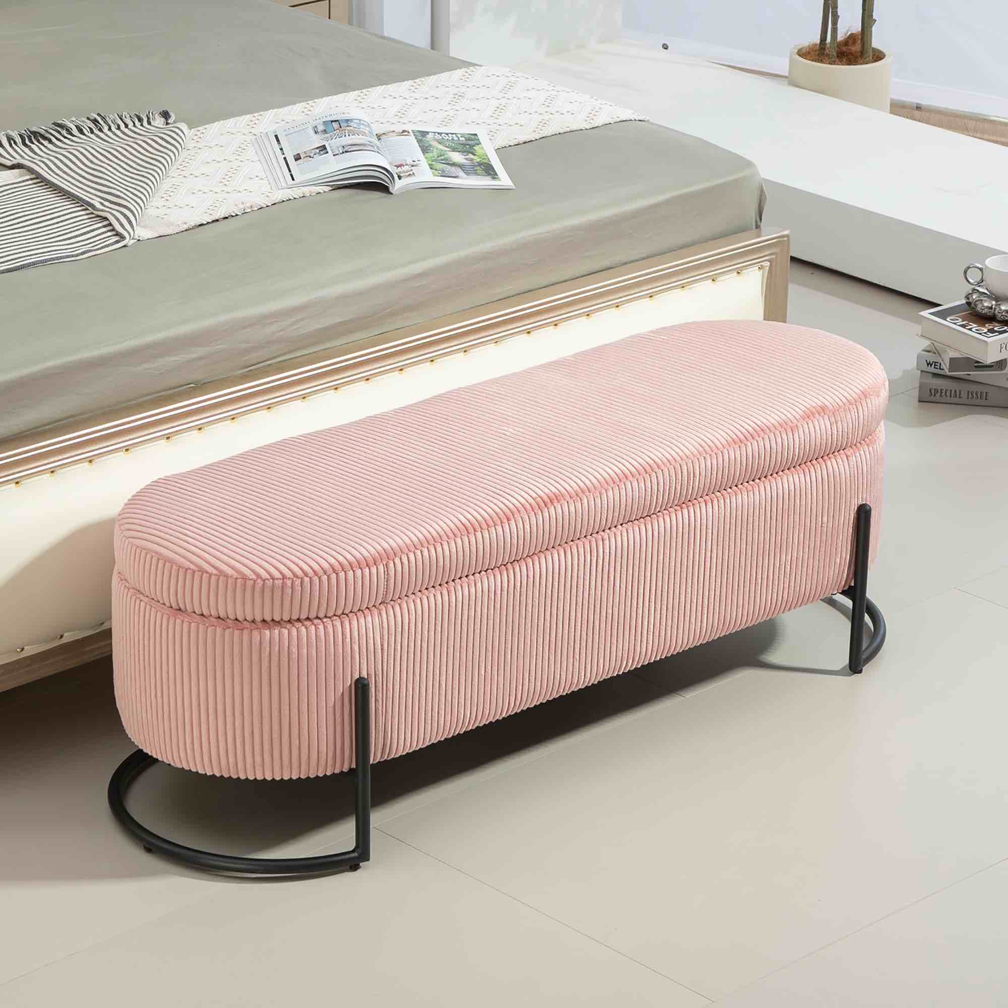 This is a pink corduroy storage ottoman bench with black metal legs.