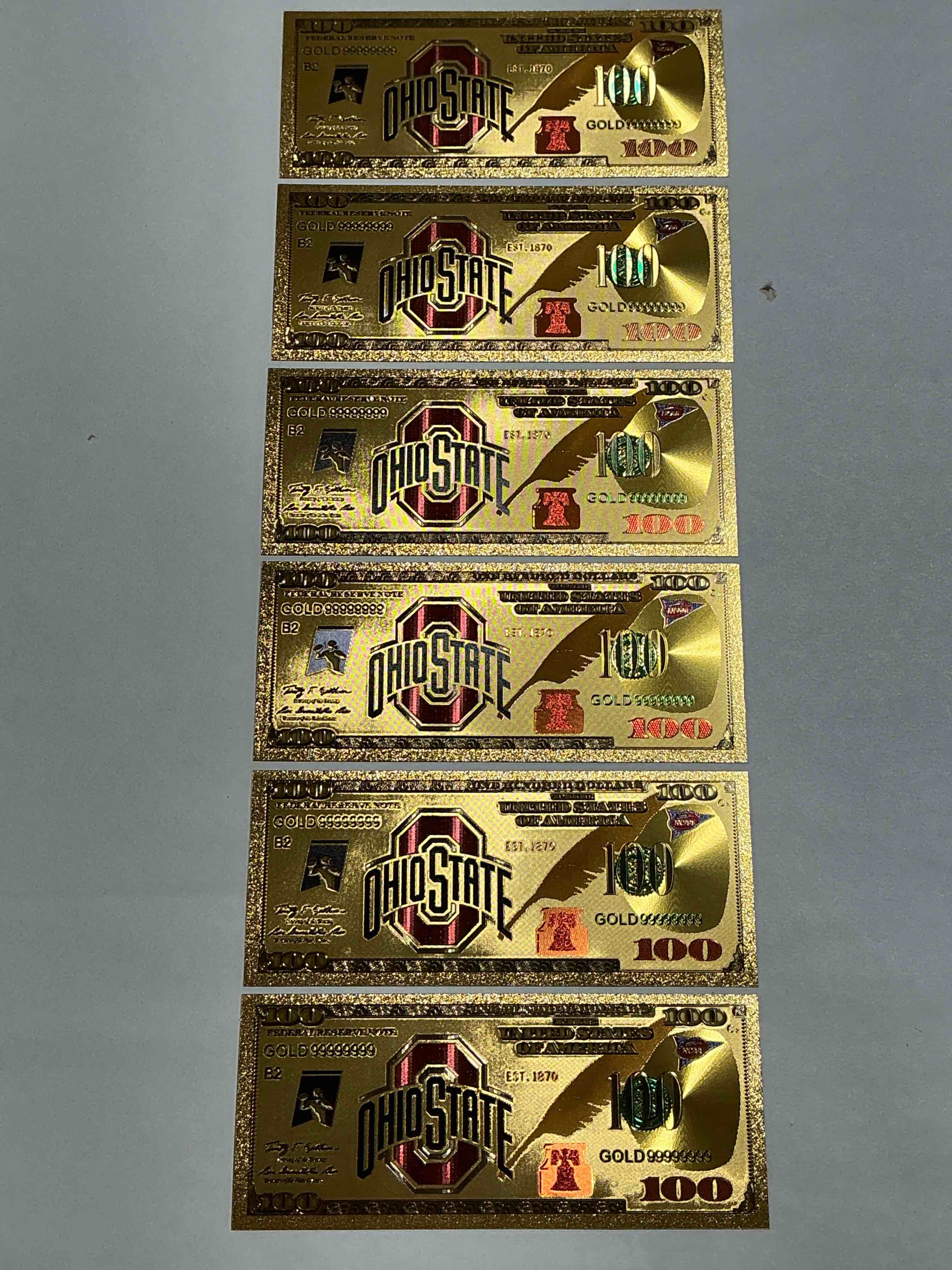 Ohio State University Collectible Memorabilia! Super Cool, Gold In Color 100 Dollar Commemorative Ohio State University Bill! Cool Designs On Front & Back Of Bill! OSU Fans Rejoice, Cool Memorabilia! Plastic Bills With Cool Designs! 