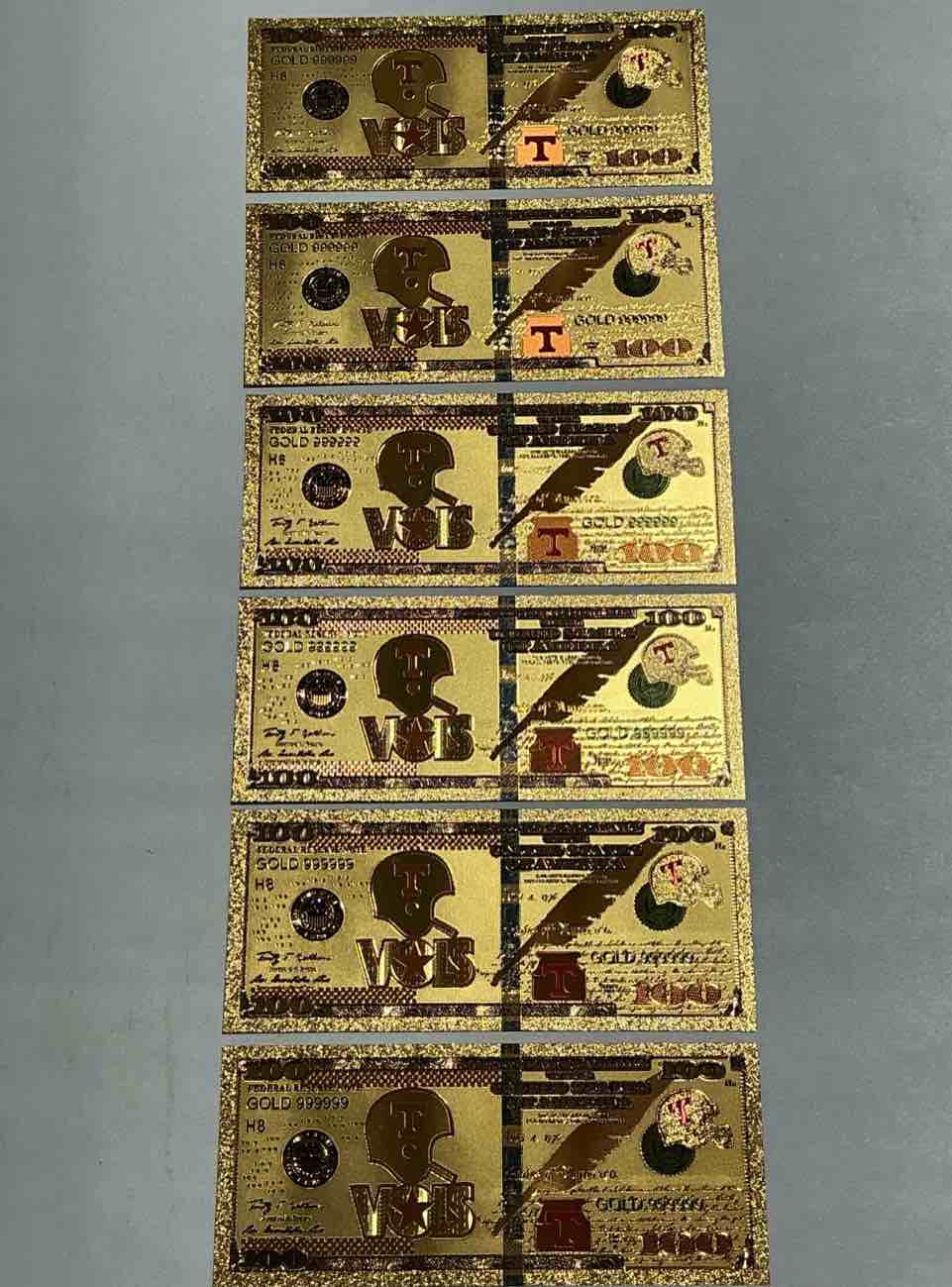 tennessee volunteers collectible memorabilia! super cool, gold in color 100 dollar commemorative ohio state university bill! cool designs on front & back of bill! ut fans rejoice, cool memorabilia! plastic bills with cool designs! 