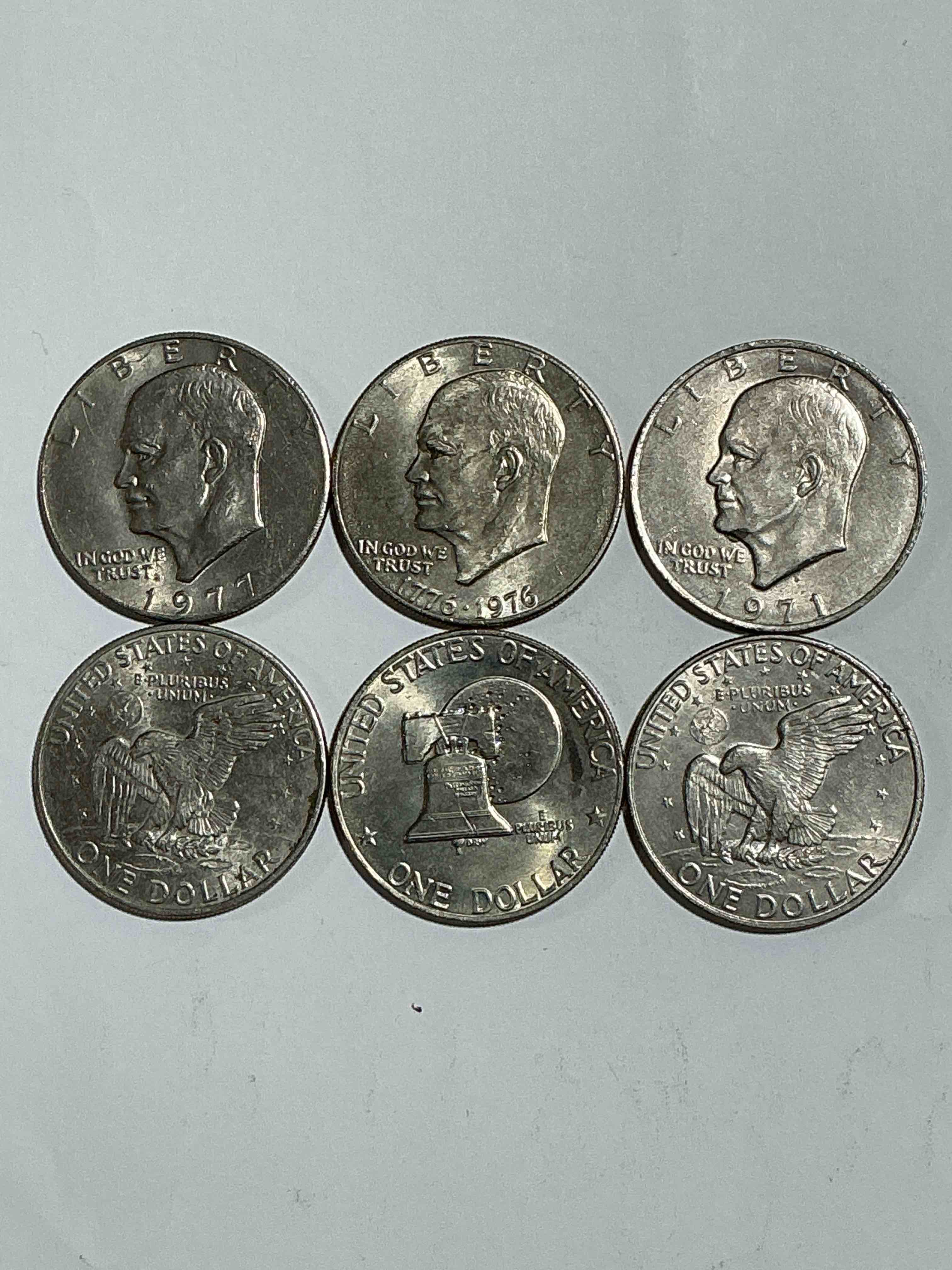 Condition photo showing Good Condition for Gorgeous Eisenhower Dollar Coins! These Striking, Large U.S. Coins Were Minted From 1971-1978. Here Are Gorgeous Examples Of “Ike" Dollars From 1976 & Other Years! These Coins Have Become Immensely Popular With Collectors & Some Have Great Toning!
