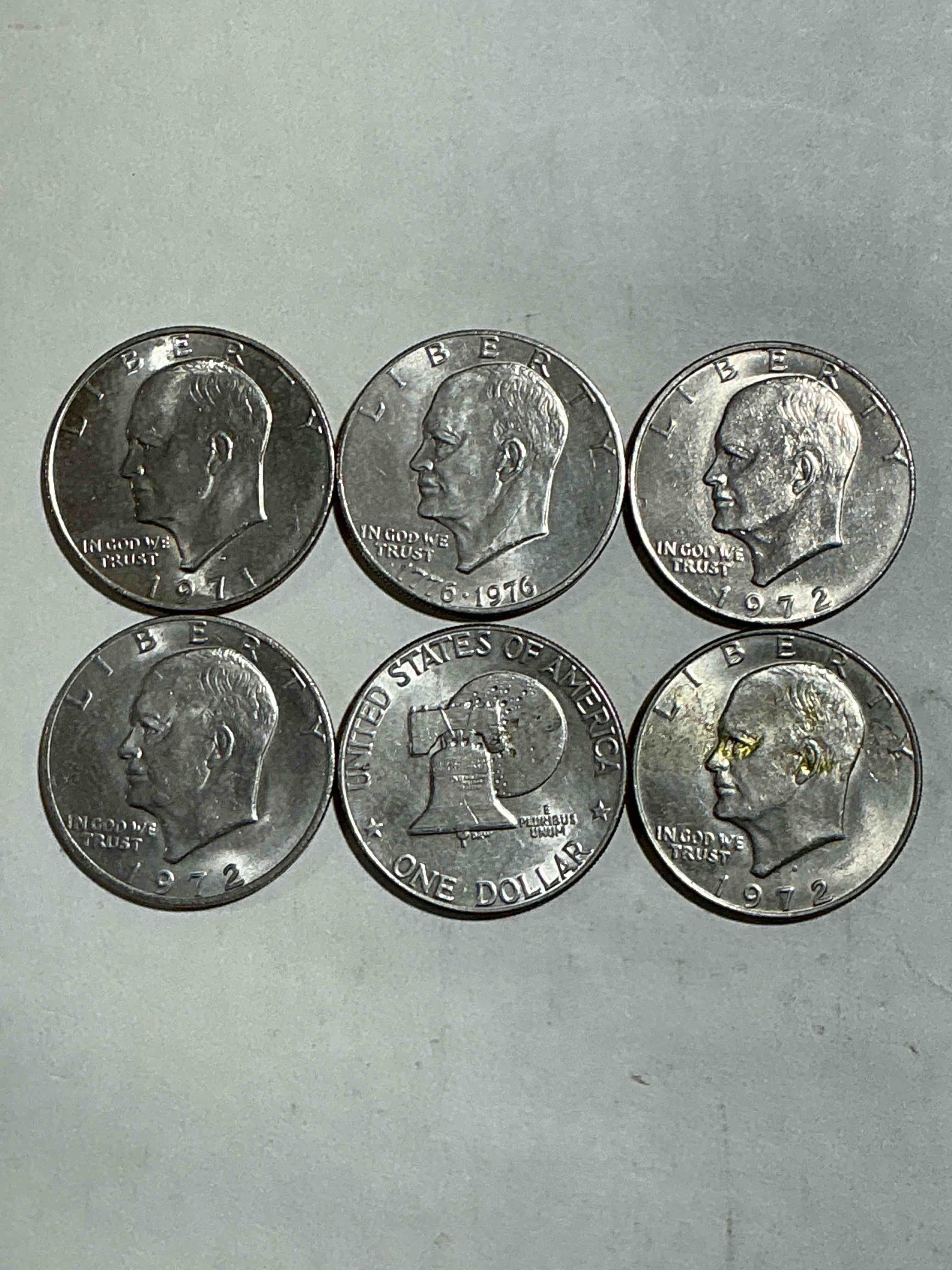 Condition photo showing Good Condition for Gorgeous Eisenhower Dollar Coins! These Striking, Large U.S. Coins Were Minted From 1971-1978. Here Are Gorgeous Examples Of “Ike" Dollars From 1976 & Other Years! These Coins Have Become Immensely Popular With Collectors & Some Have Great Toning!