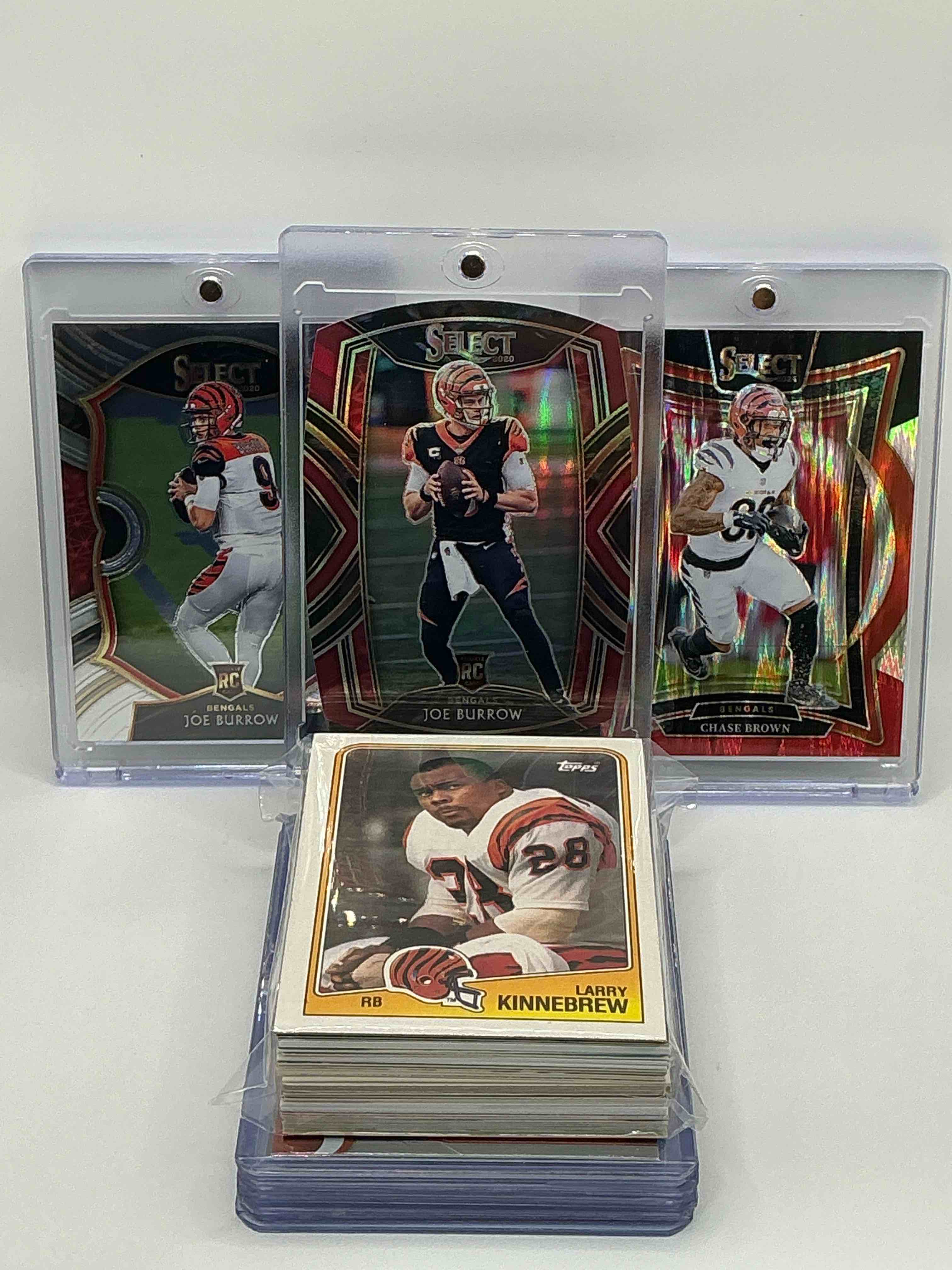 bengals bonanza! 2020 select die-cut club level rookie joe burrow! 2020 select concourse level rookie joe burrow! 2024 select orange & black concourse level chase brown! along with 50 other bengals heroes, legends & commons!