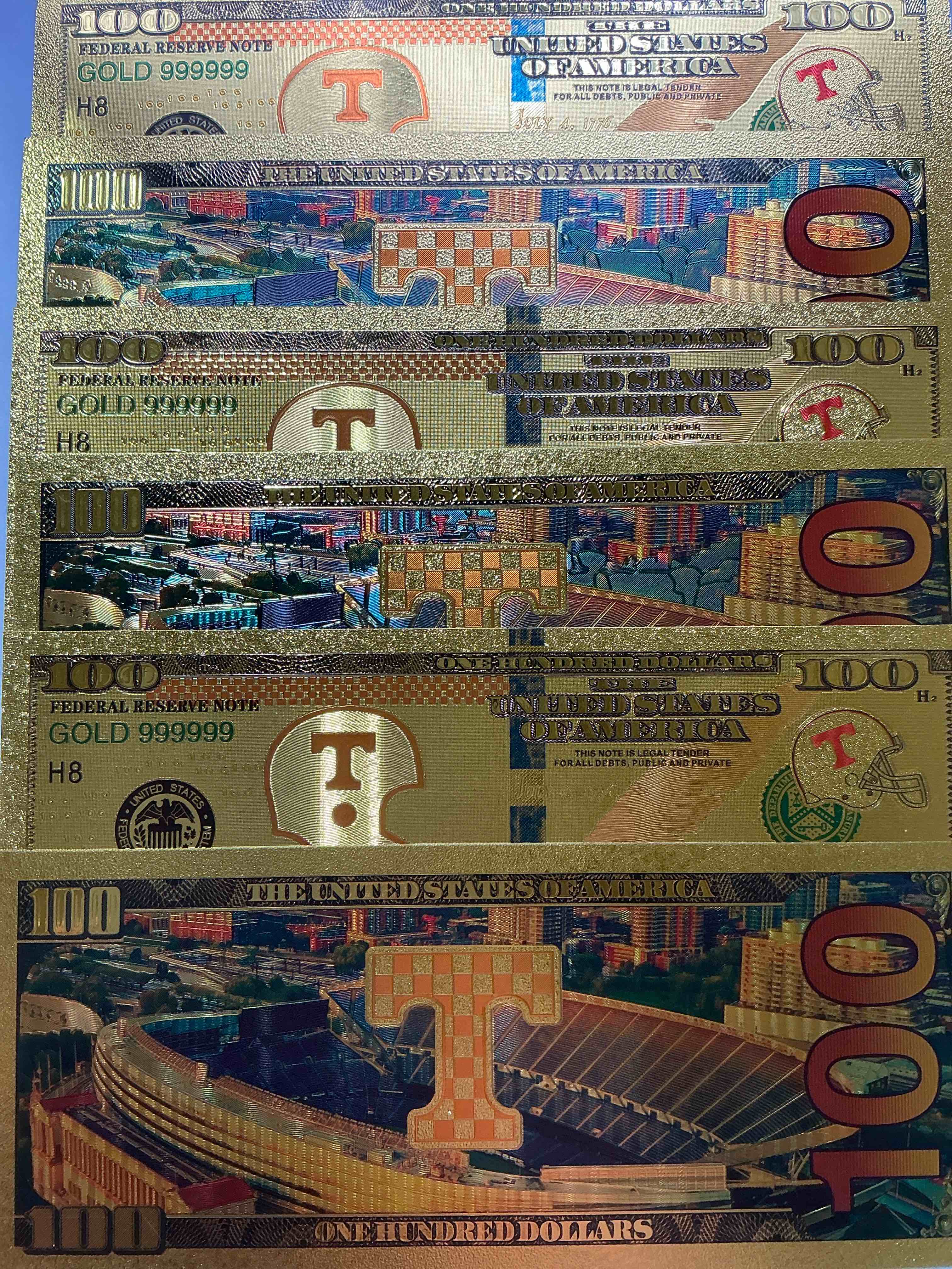 tennessee volunteers collectible memorabilia! super cool, gold in color 100 dollar commemorative ohio state university bill! cool designs on front & back of bill! ut fans rejoice, cool memorabilia! plastic bills with cool designs! 