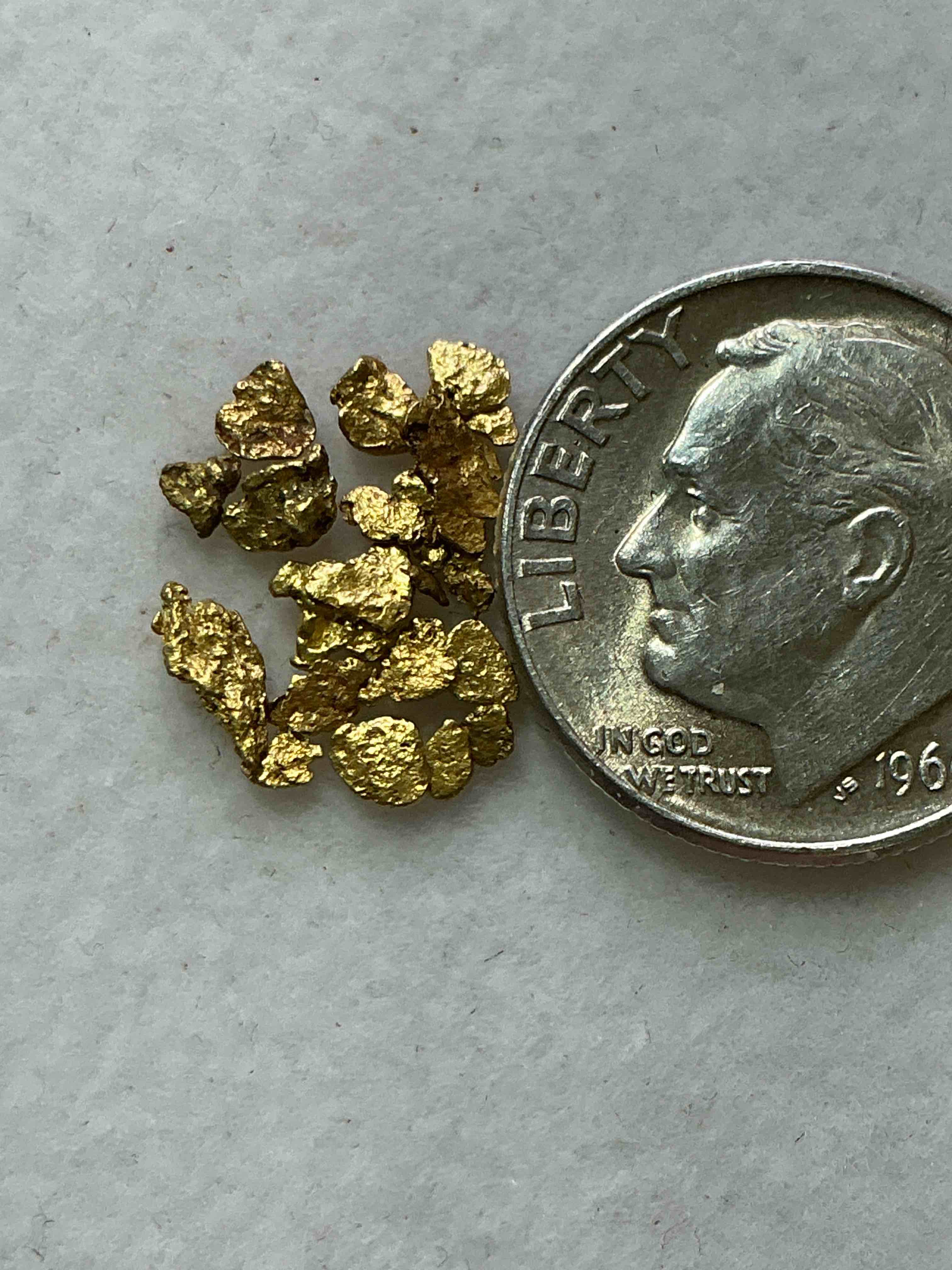Condition photo showing New/Like New for Genuine Gold Nuggets! Gold Nuggets Fresh From Prospecting North Carolina Mountains, Total Weight Of All Nuggets Is Approximately .5 Grams. These Gold Nuggets Typically Test At Between Approx 22-24 Karat. Gold In Raw, Prospected Form Is Extremely Hard To Find & Much Rarer Than Any Refined Form. Get In On The Gold Craze... Gold Has Increased In Value Over 40% In 2025 Alone! U.S. Dime For Size Reference Only (not included). Gold Vile In Image Included. Own Genuine, Gold Nuggets! 