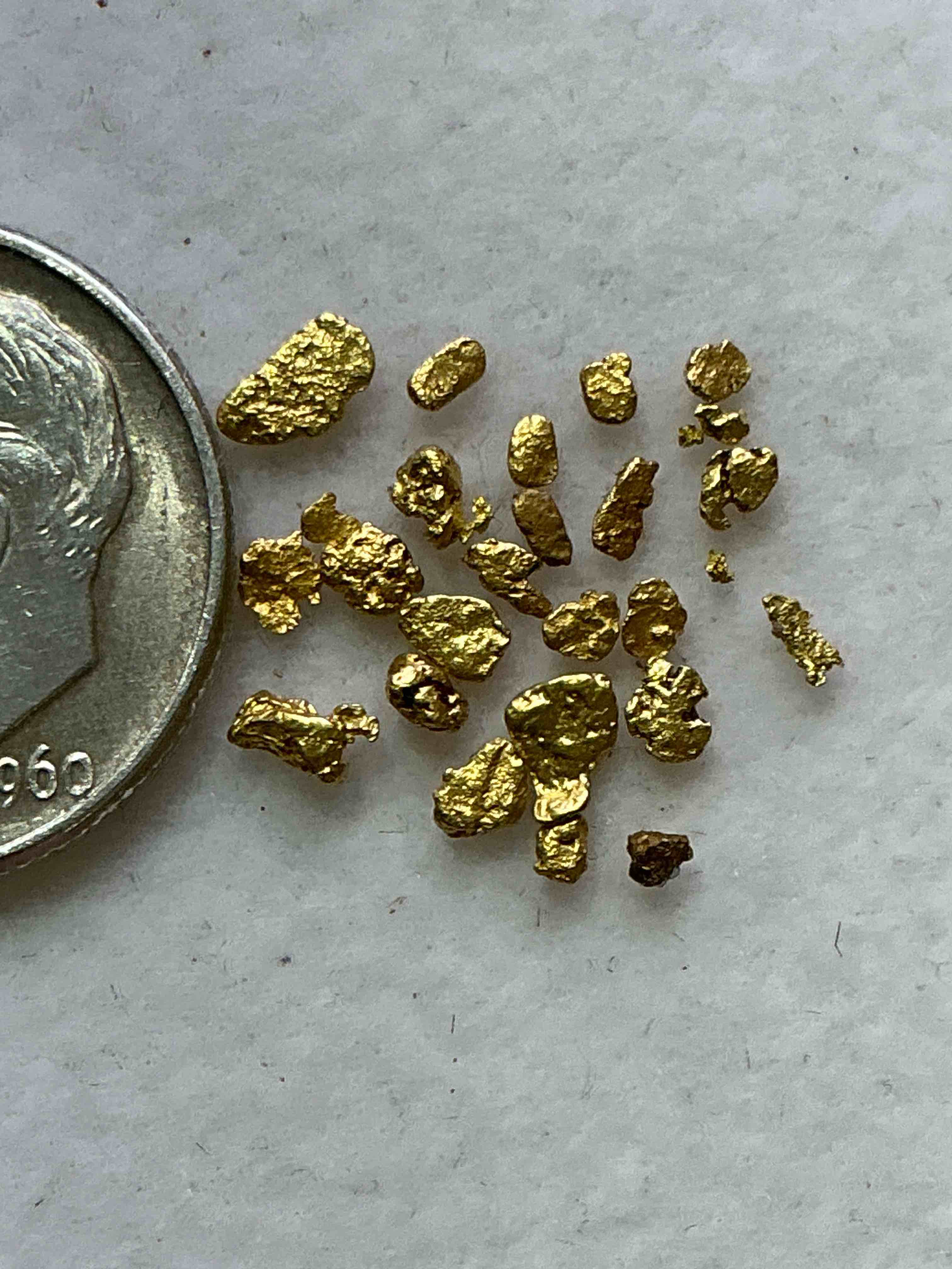 Condition photo showing New/Like New for Genuine Gold Nuggets! Gold Nuggets Fresh From Prospecting North Carolina Mountains, Total Weight Of All Nuggets Is Approximately .5 Grams. These Gold Nuggets Typically Test At Between Approx 22-24 Karat. Gold In Raw, Prospected Form Is Extremely Hard To Find & Much Rarer Than Any Refined Form. Get In On The Gold Craze... Gold Has Increased In Value Over 40% In 2025 Alone! U.S. Dime For Size Reference Only (not included). Gold Vile In Image Included. Own Genuine, Gold Nuggets!