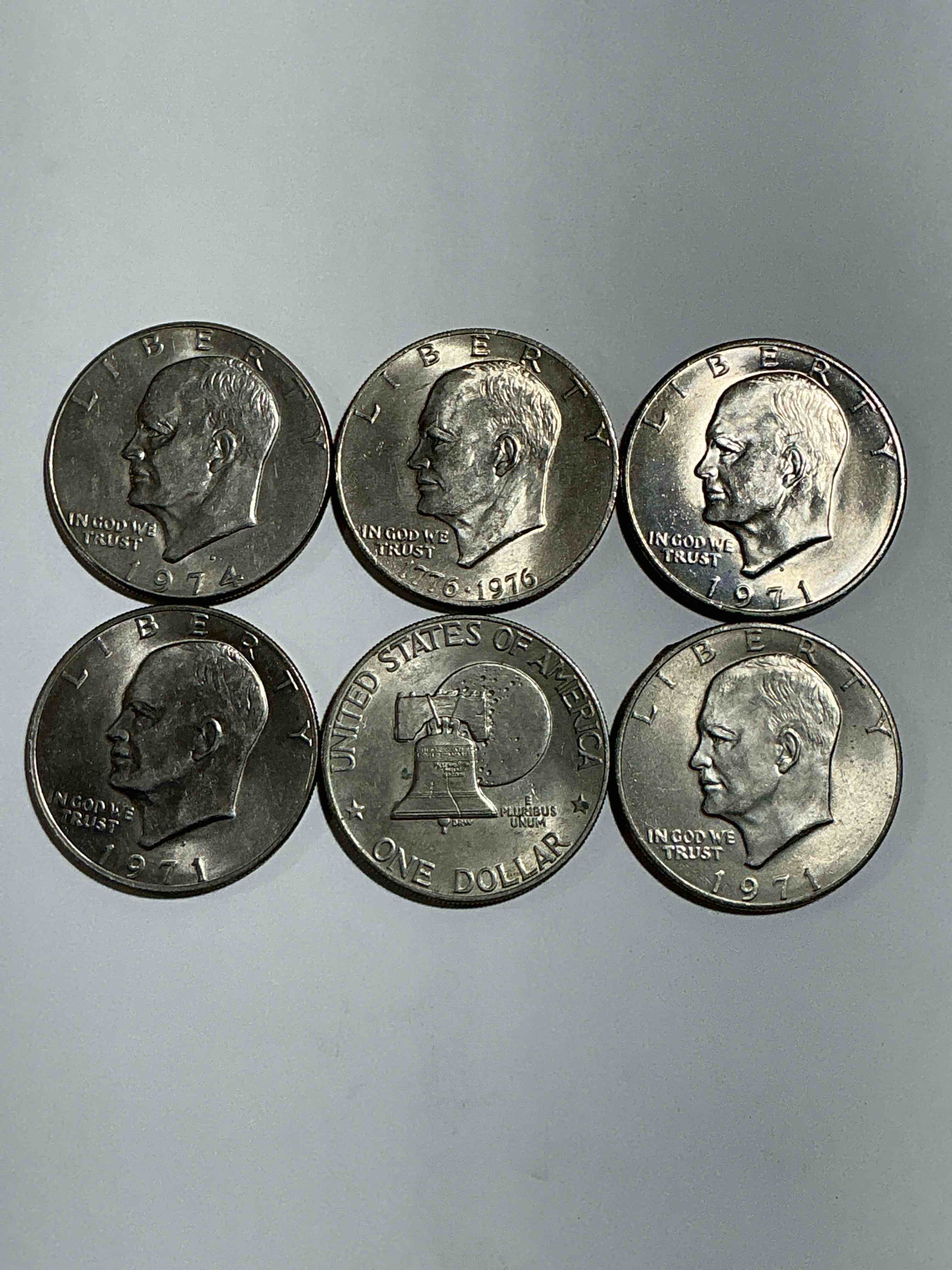 Condition photo showing Good Condition for Gorgeous Eisenhower Dollar Coins! These Striking, Large U.S. Coins Were Minted From 1971-1978. Here Are Gorgeous Examples Of “Ike" Dollars From 1976 & Other Years! These Coins Have Become Immensely Popular With Collectors & Some Have Great Toning!