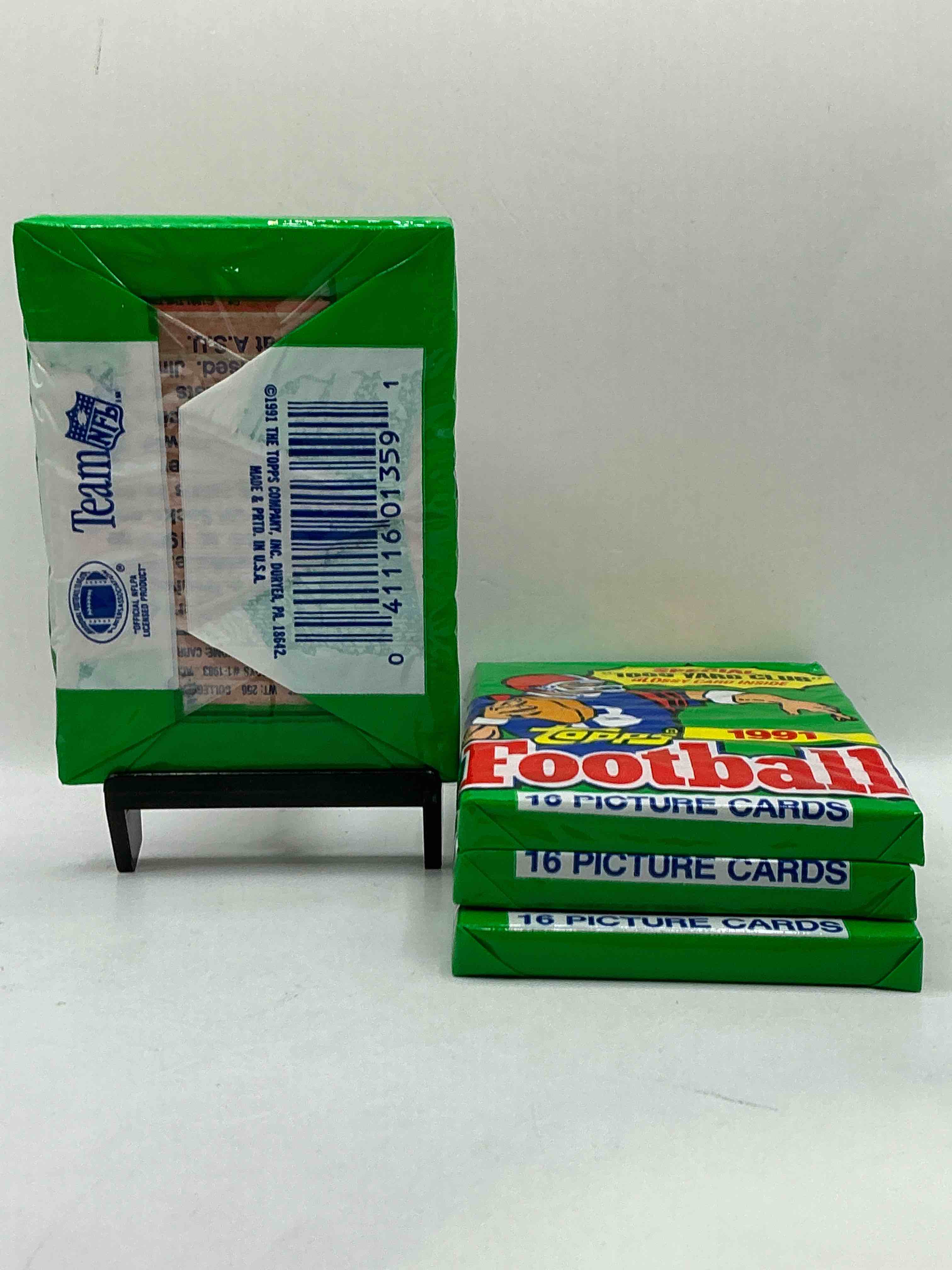 Condition photo showing New/Like New for 1991 Topps Football Unopened Sports Card Wax Pack, Direct From Original Retail Case. Search For Early Barry Sanders, Emmitt Smith, Jerry Rice & Joe Montana!