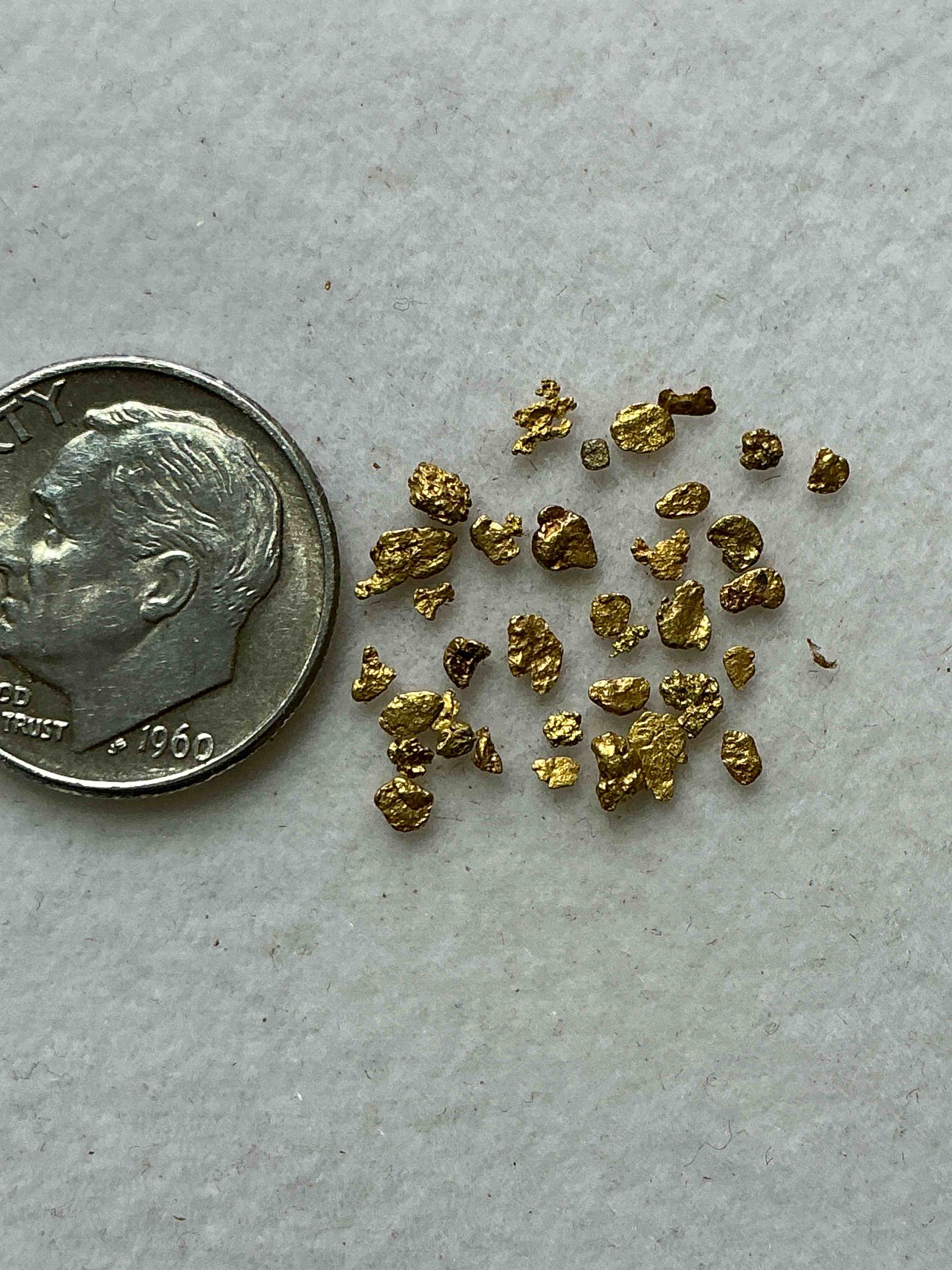 Condition photo showing Good Condition for Genuine Gold Nuggets! Gold Nuggets Fresh From Prospecting North Carolina Mountains, Total Weight Of All Nuggets Is Approximately .5 Grams. These Gold Nuggets Typically Test At Between Approx 22-24 Karat. Gold In Raw, Prospected Form Is Extremely Hard To Find & Much Rarer Than Any Refined Form. Get In On The Gold Craze... Gold Has Increased In Value Over 40% In 2025 Alone! U.S. Dime For Size Reference Only (not included). Gold Vile In Image Included. Own Genuine, Gold Nuggets!