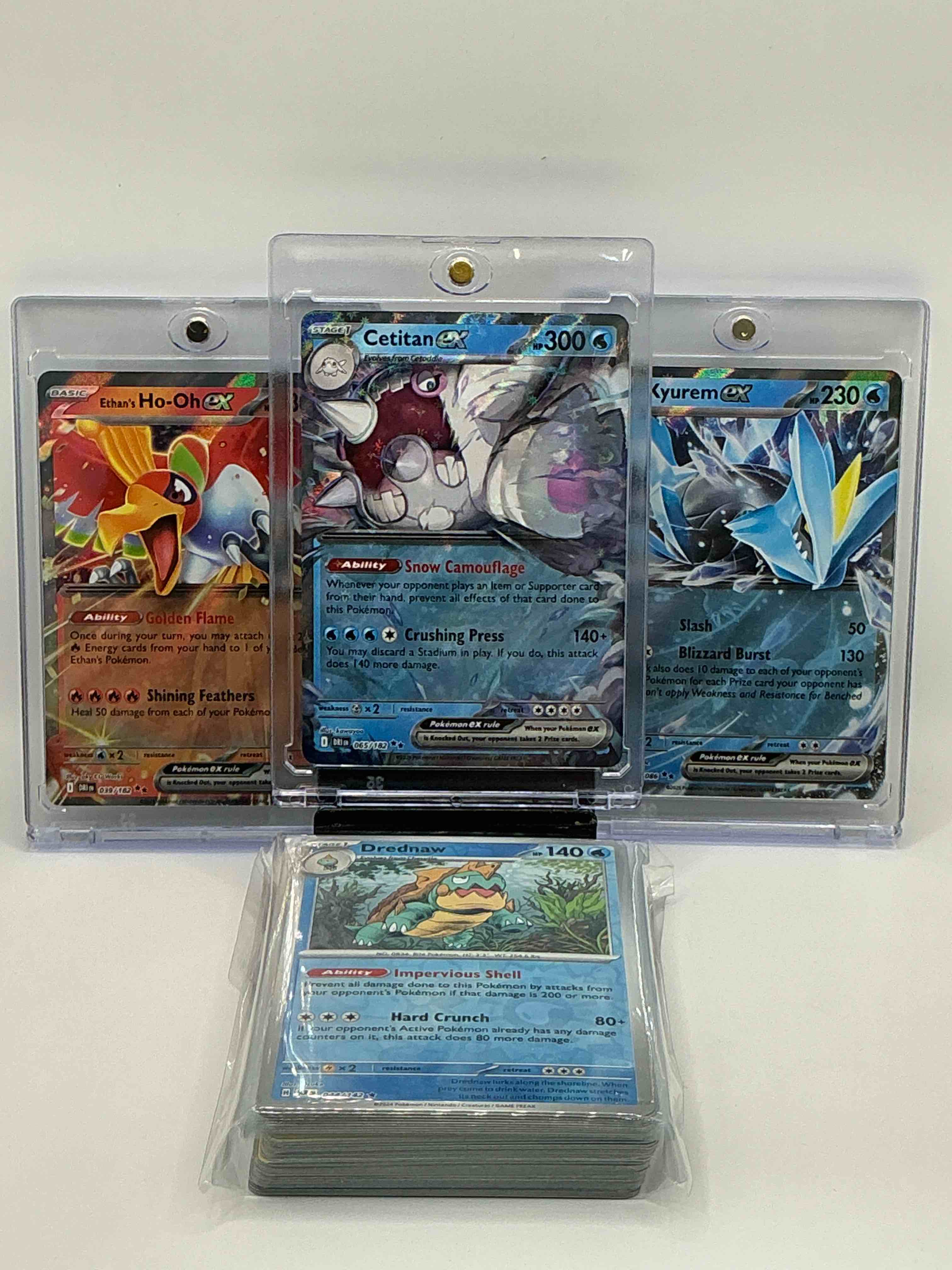 pokémon palooza! silver & blue shimmer snow camouflage crushing press ceritan ex! silver & blue shimmer slash blizzard burst kyurem ex! silver & orange shimmer golden flame shining feather ethan’s ho-oh ex! along with 50 pokémon heroes, holos, legends & commons!