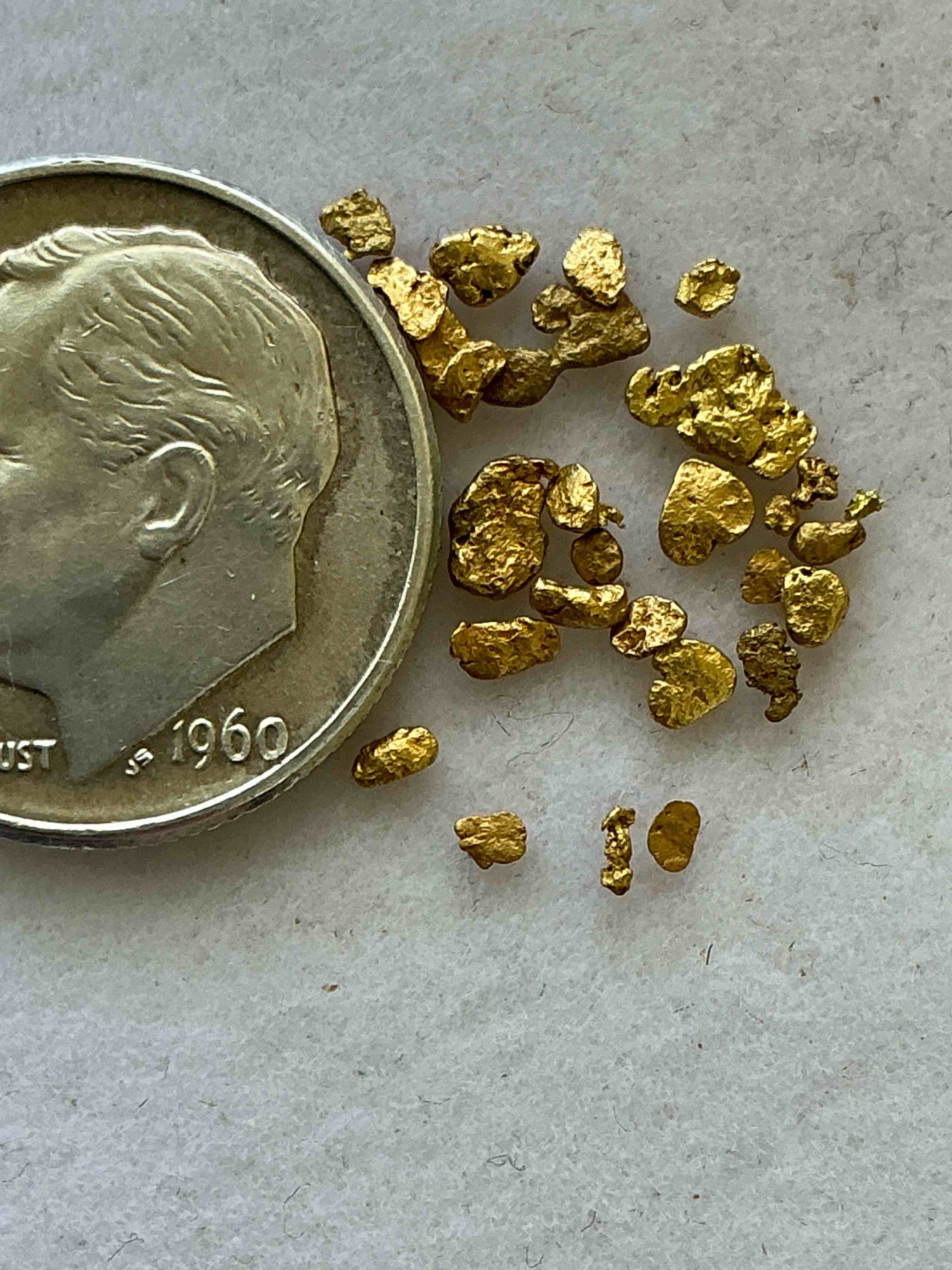 Condition photo showing New/Like New for Genuine Gold Nuggets! Gold Nuggets Fresh From Prospecting North Carolina Mountains, Total Weight Of All Nuggets Is Approximately .5 Grams. These Gold Nuggets Typically Test At Between Approx 22-24 Karat. Gold In Raw, Prospected Form Is Extremely Hard To Find & Much Rarer Than Any Refined Form. Get In On The Gold Craze... Gold Has Increased In Value Over 40% Since 2025! U.S. Dime For Size Reference Only (not included). Gold Vile In Image Included. Own Genuine, Gold Nuggets!
