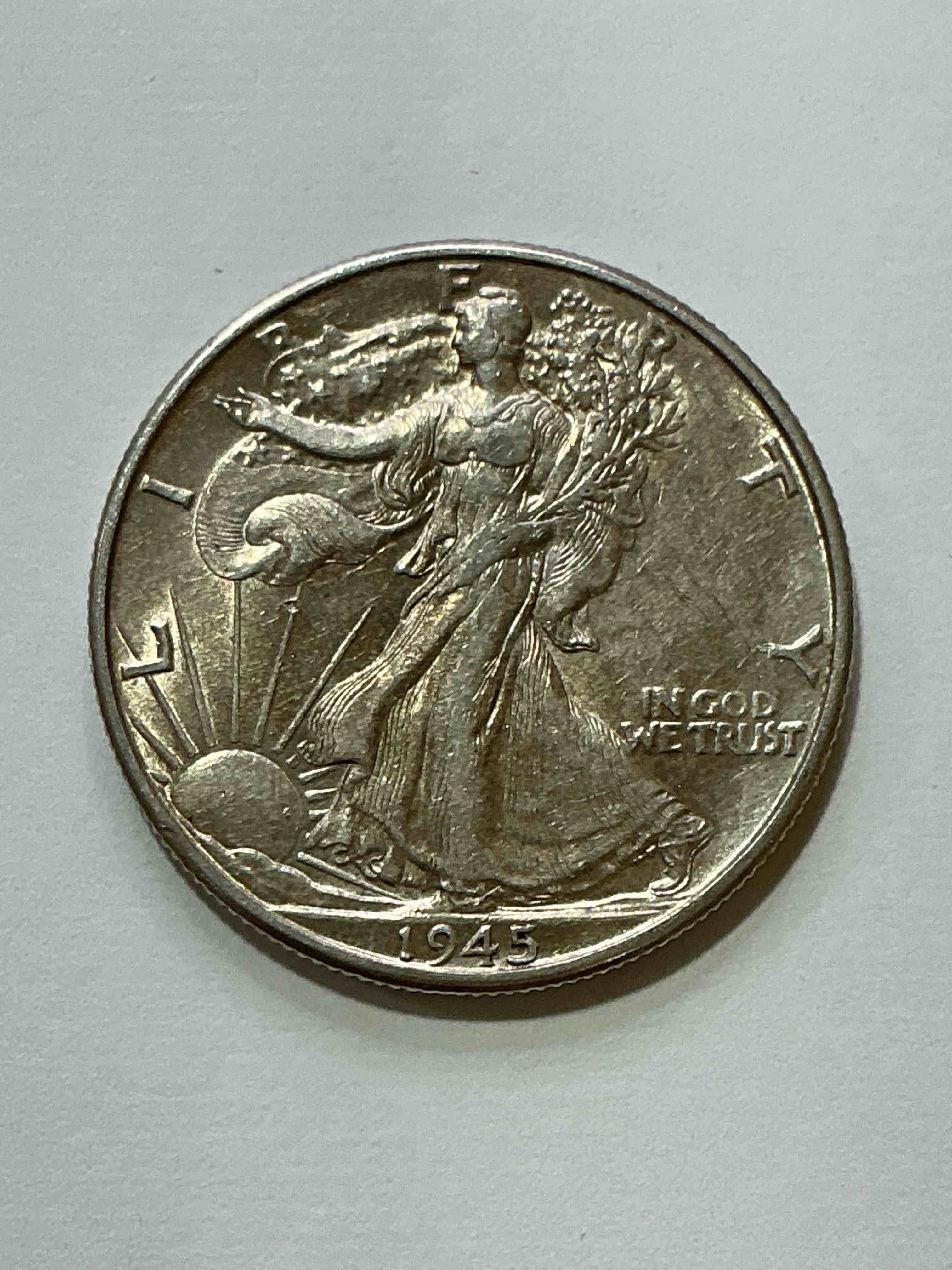 World War II Era Silver! Antique U.S. Silver! Liberty Walking Silver Fine U.S. Silver Half Dollar! This Striking Half Dollars Were Minted From 1916-1947 & Have Become Some Of The Most Collectible Coins In History! Here Is A Striking Appears Uncirculated Example From 1945! Liberty Walking Coins Are 90% Fine U.S. Silver, A Great Investment In Precious Metal!