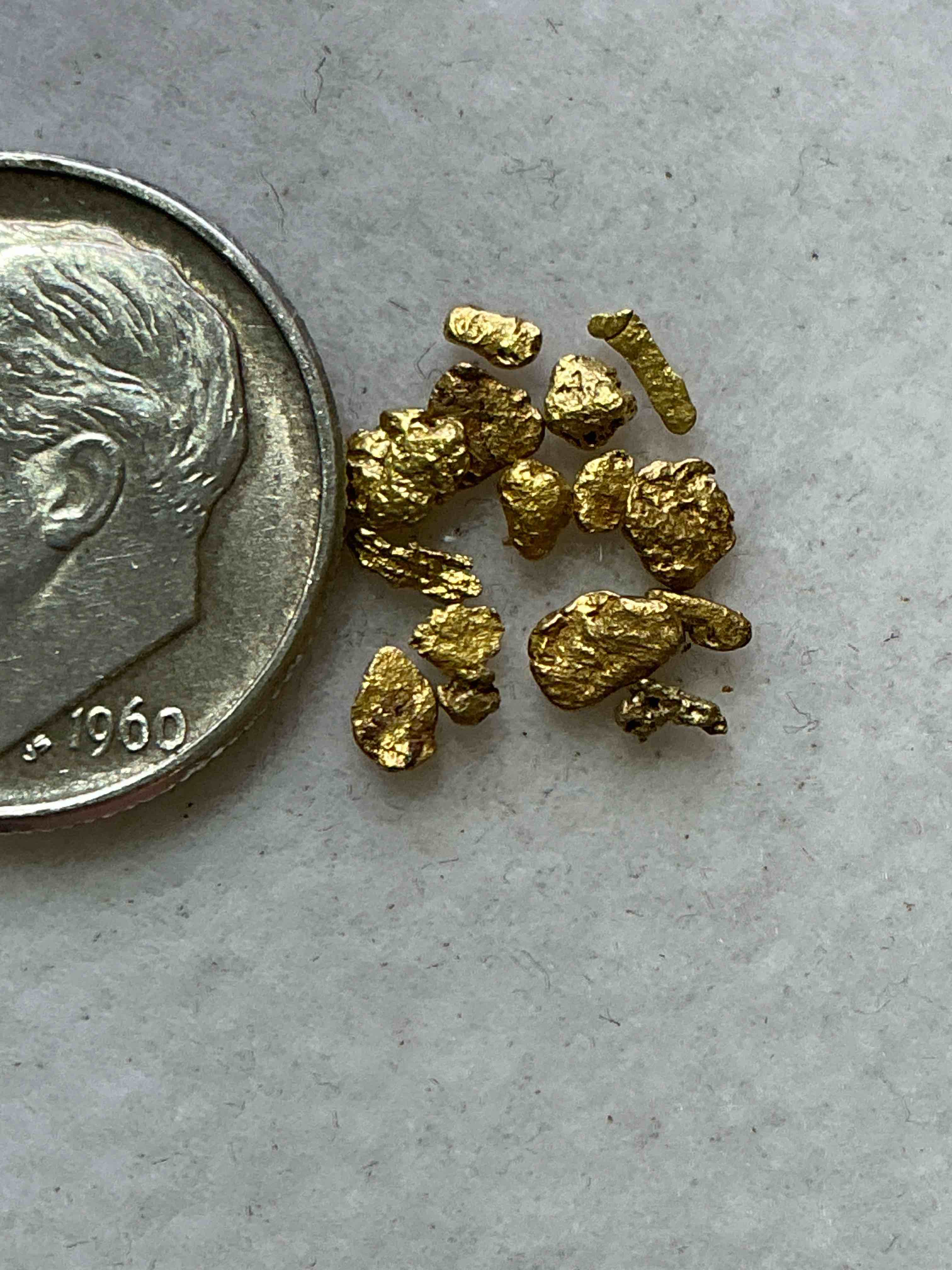 Condition photo showing New/Like New for Genuine Gold Nuggets! Gold Nuggets Fresh From Prospecting North Carolina Mountains, Total Weight Of All Nuggets Is Approximately .5 Grams. These Gold Nuggets Typically Test At Between Approx 22-24 Karat. Gold In Raw, Prospected Form Is Extremely Hard To Find & Much Rarer Than Any Refined Form. Get In On The Gold Craze... Gold Has Increased In Value Over 40% Since 2025! U.S. Dime For Size Reference Only (not included). Gold Vile In Image Included. Own Genuine, Gold Nuggets!