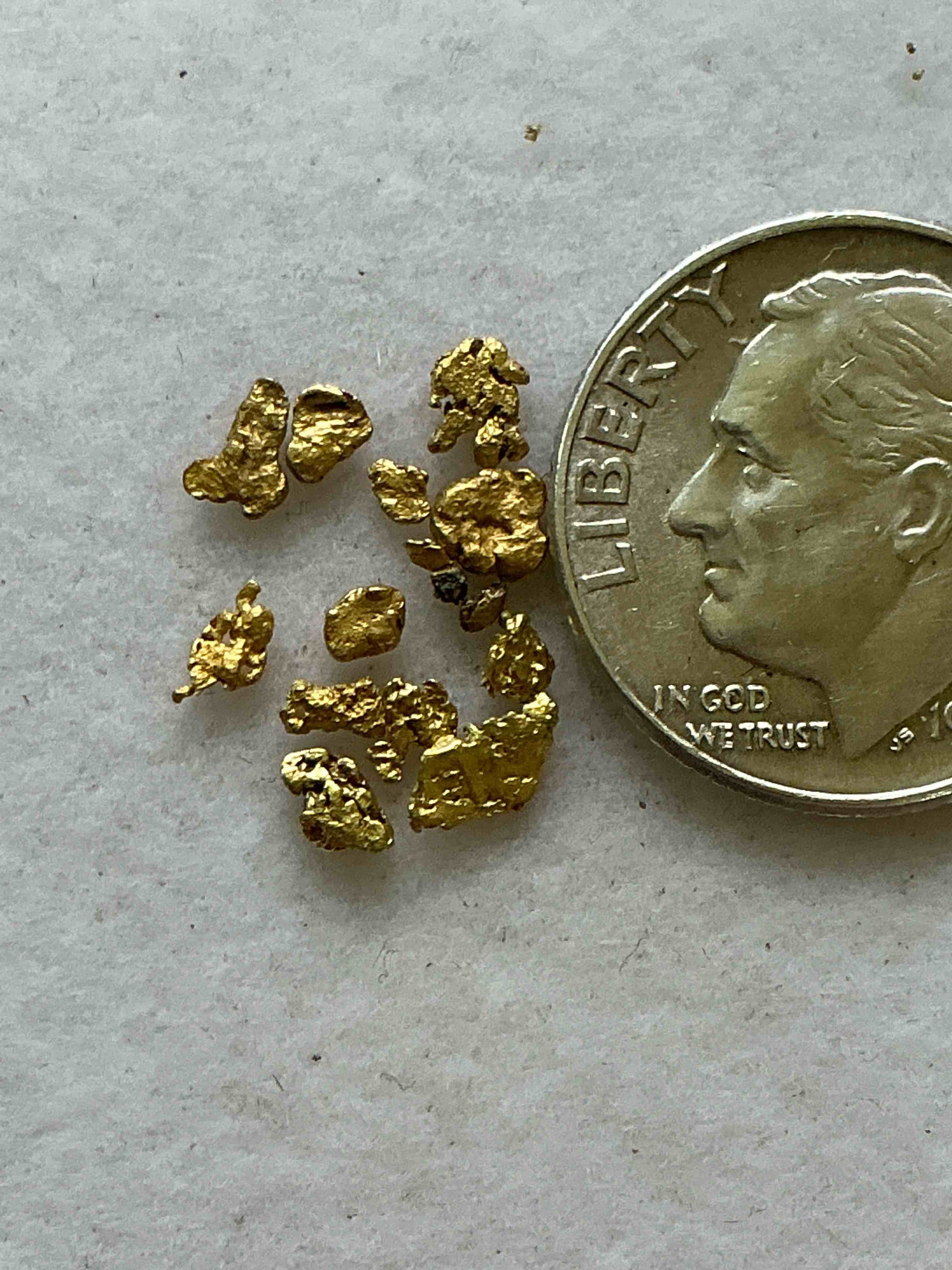 Condition photo showing New/Like New for Genuine Gold Nuggets! Gold Nuggets Fresh From Prospecting North Carolina Mountains, Total Weight Of All Nuggets Is Approximately .5 Grams. These Gold Nuggets Typically Test At Between Approx 22-24 Karat. Gold In Raw, Prospected Form Is Extremely Hard To Find & Much Rarer Than Any Refined Form. Get In On The Gold Craze... Gold Has Increased In Value Over 40% Since 2025! U.S. Dime For Size Reference Only (not included). Gold Vile In Image Included. Own Genuine, Gold Nuggets! 