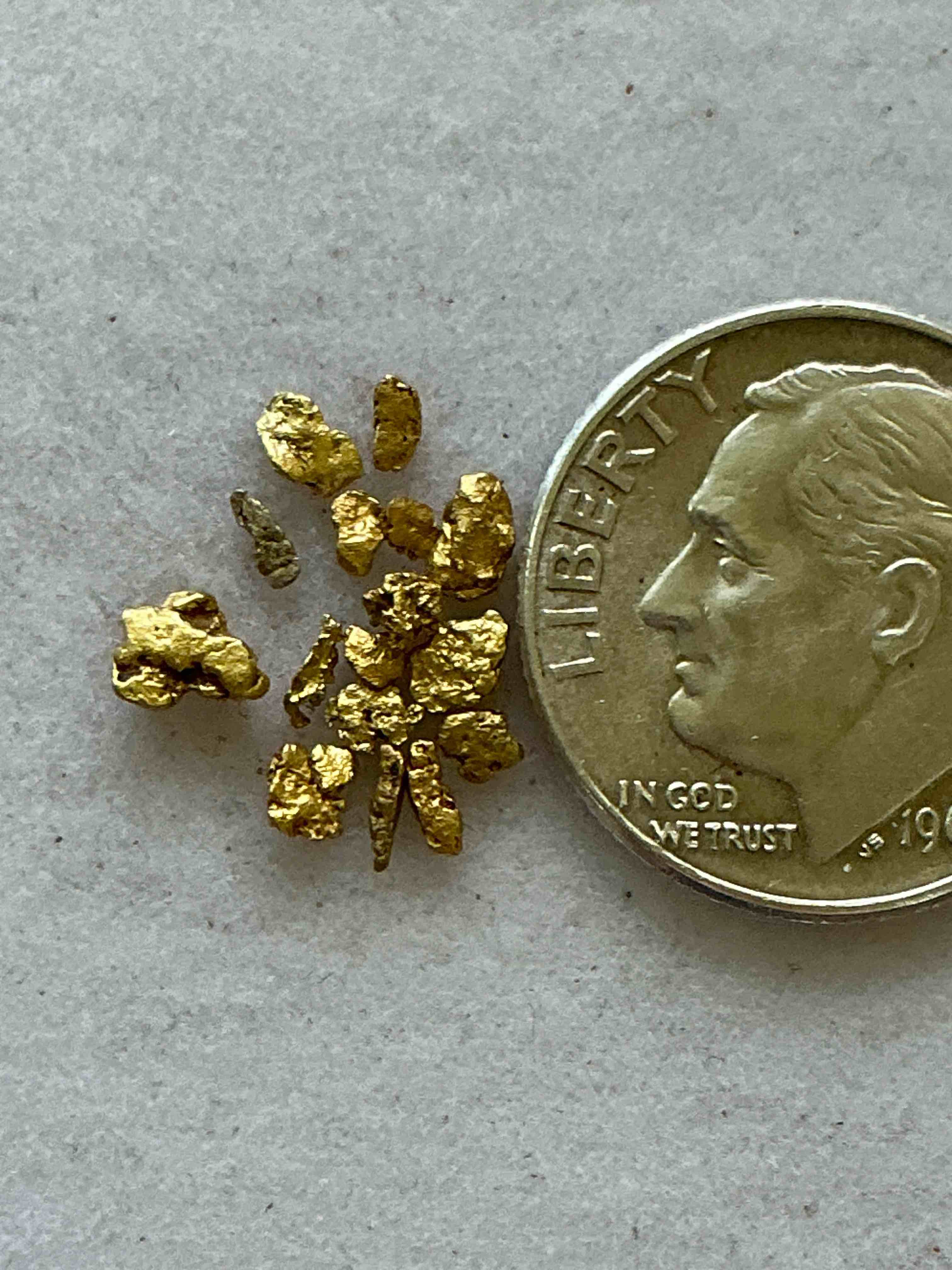 Condition photo showing New/Like New for Genuine Gold Nuggets! Gold Nuggets Fresh From Prospecting North Carolina Mountains, Total Weight Of All Nuggets Is Approximately .5 Grams. These Gold Nuggets Typically Test At Between Approx 22-24 Karat. Gold In Raw, Prospected Form Is Extremely Hard To Find & Much Rarer Than Any Refined Form. Get In On The Gold Craze... Gold Has Increased In Value Over 40% Since 2025! U.S. Dime For Size Reference Only (not included). Gold Vile In Image Included. Own Genuine, Gold Nuggets! 
