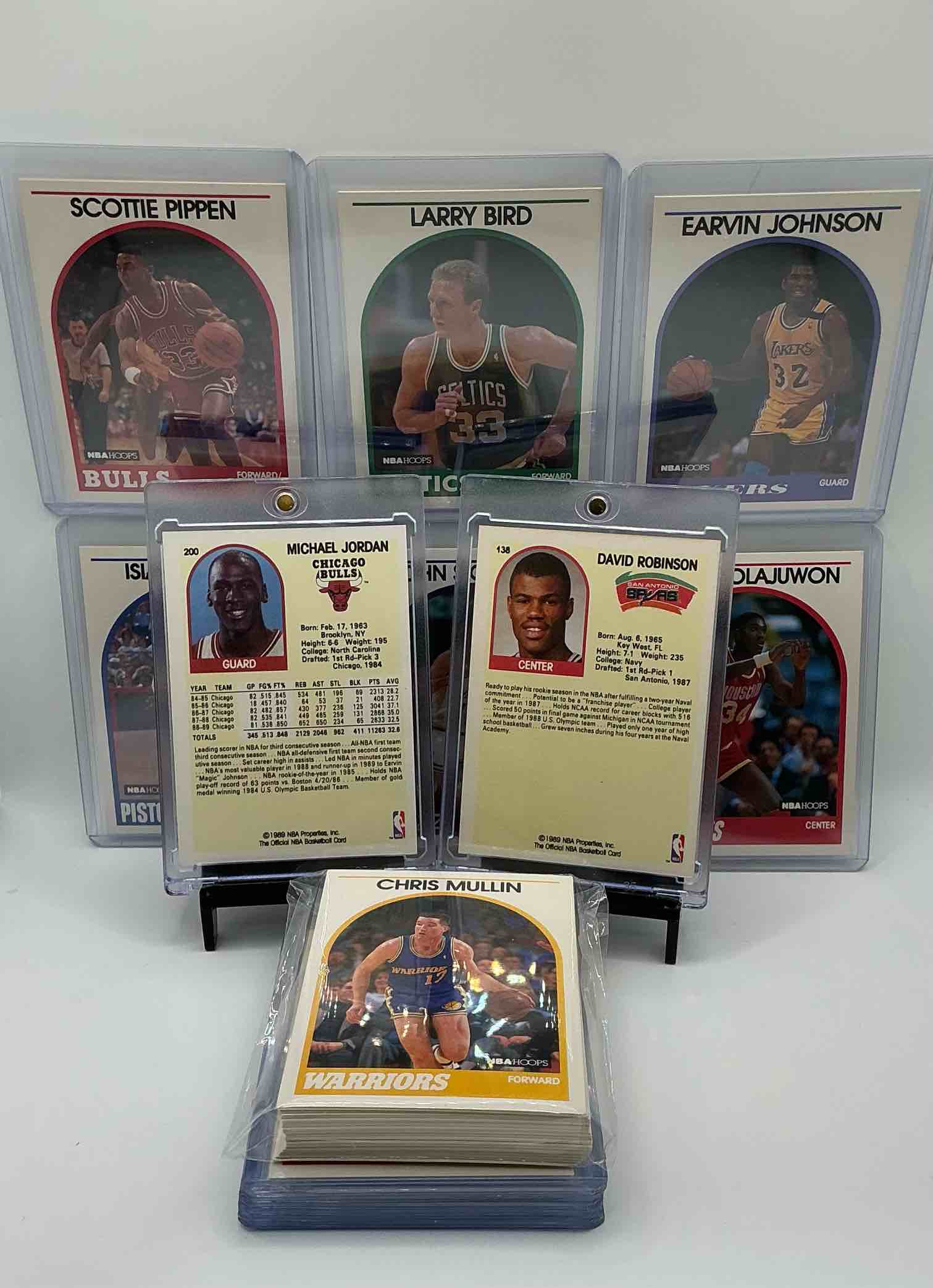 Condition photo showing New/Like New for 1989 NBA Basketball! David Robinson Rookie! 1989 NBA Card Combo! The BEST Cards From The Year! Michael Jordan, Magic Johnson, Larry Bird, Scottie Pippen, Charles Barkley, John Stockton, Reggie Miller, Isiah Thomas, Akeem Olajuwon, Clyde Drexler, Karl Malone & So Many More! 50 Card Lot! All Stars, Hall Of Famers, Champions & More, The Perfect Mix Of Miscellaneous '89 NBA Variety!