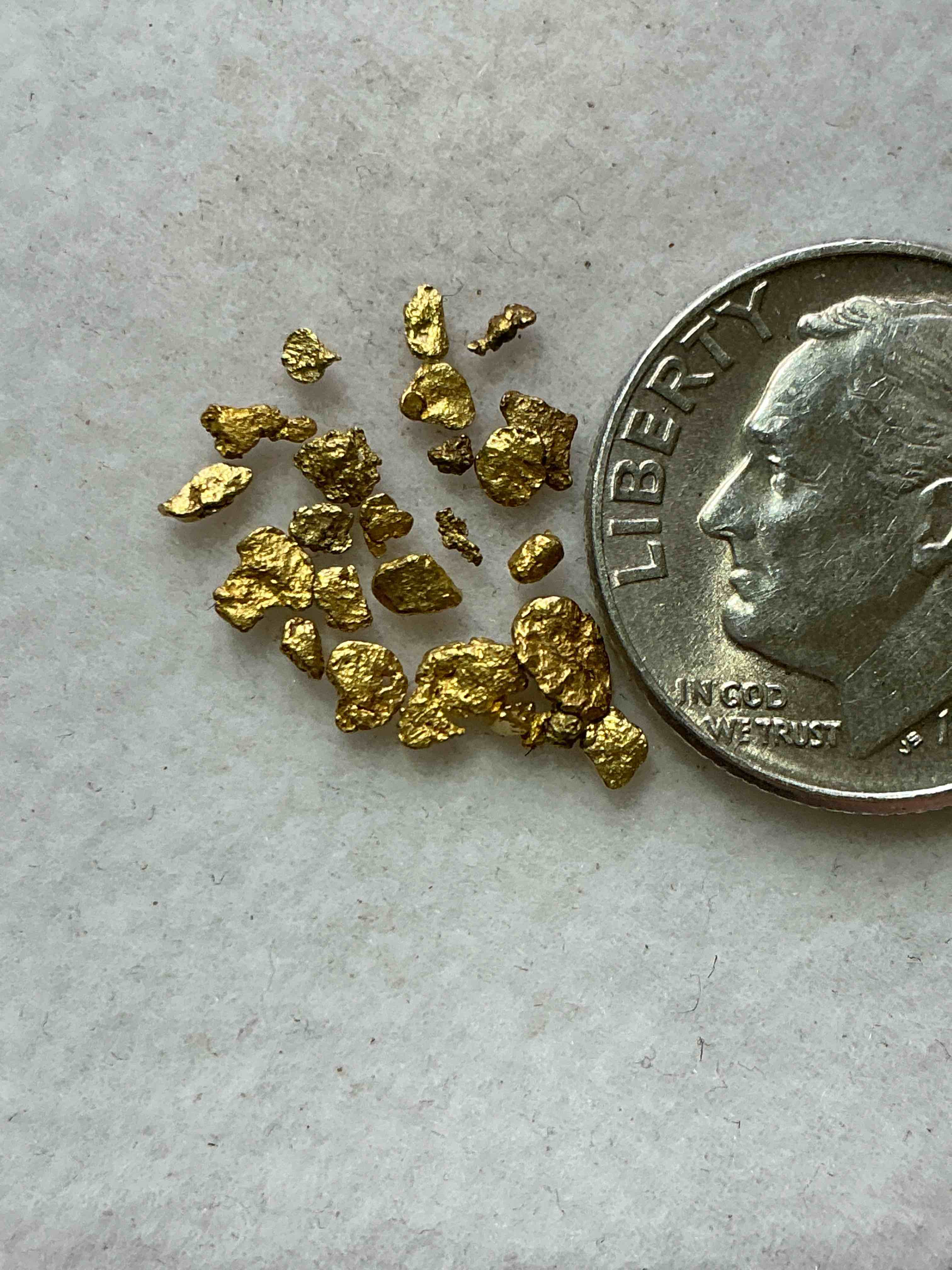 Condition photo showing New/Like New for Genuine Gold Nuggets! Gold Nuggets Fresh From Prospecting North Carolina Mountains, Total Weight Of All Nuggets Is Approximately .5 Grams. These Gold Nuggets Typically Test At Between Approx 22-24 Karat. Gold In Raw, Prospected Form Is Extremely Hard To Find & Much Rarer Than Any Refined Form. Get In On The Gold Craze... Gold Has Increased In Value Over 40% Since 2025! U.S. Dime For Size Reference Only (not included). Gold Vile In Image Included. Own Genuine, Gold Nuggets!