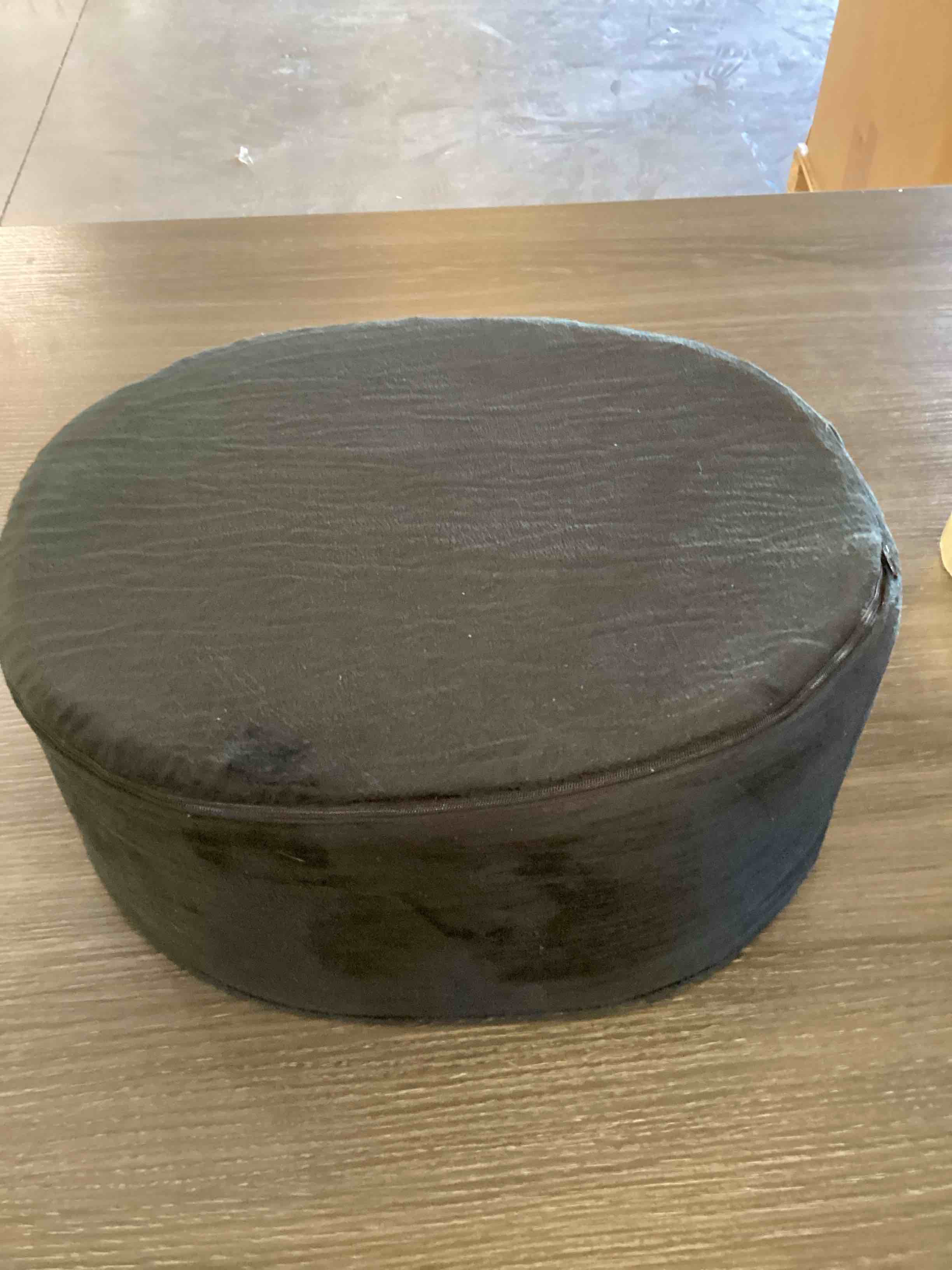Condition photo showing As Is for oval shaped cushion pillow, black
