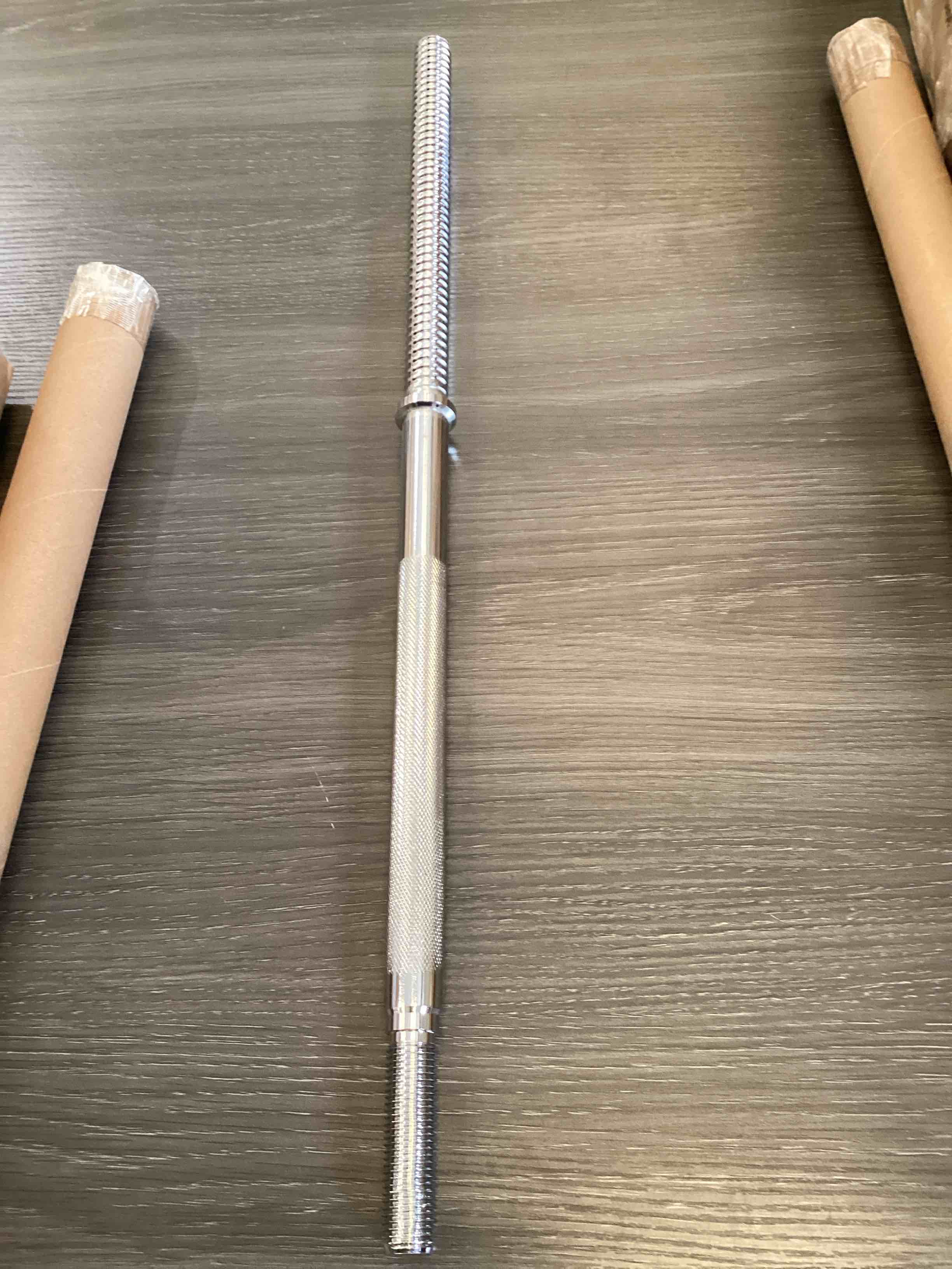 solid steel barbell bar with knurled grips and threaded ends for securing weights.