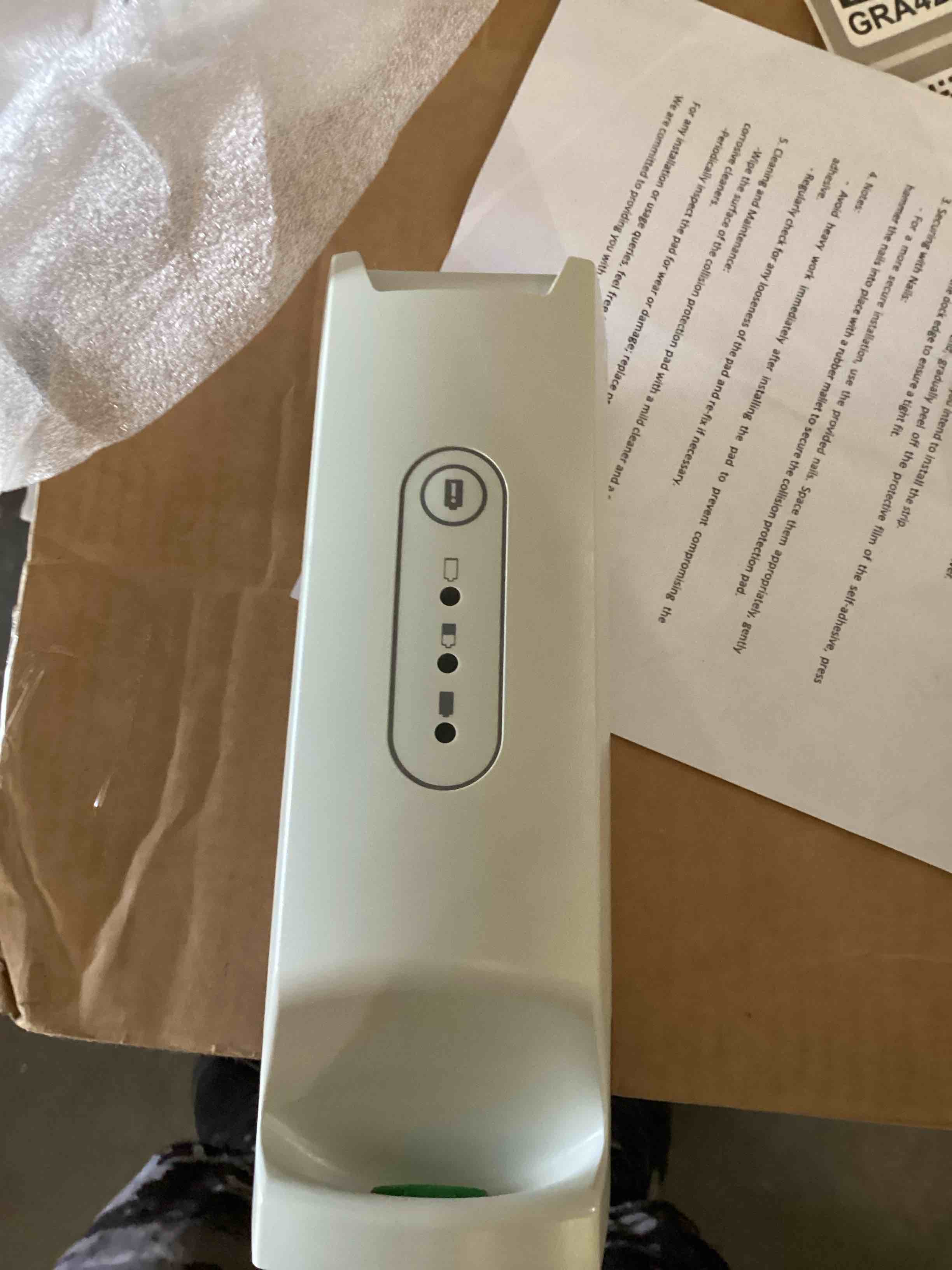 Condition photo showing As Is for this white electronic device is a hillrom extra battery box, model number 2006107, used for patient lifts like the liko golvo 8008.