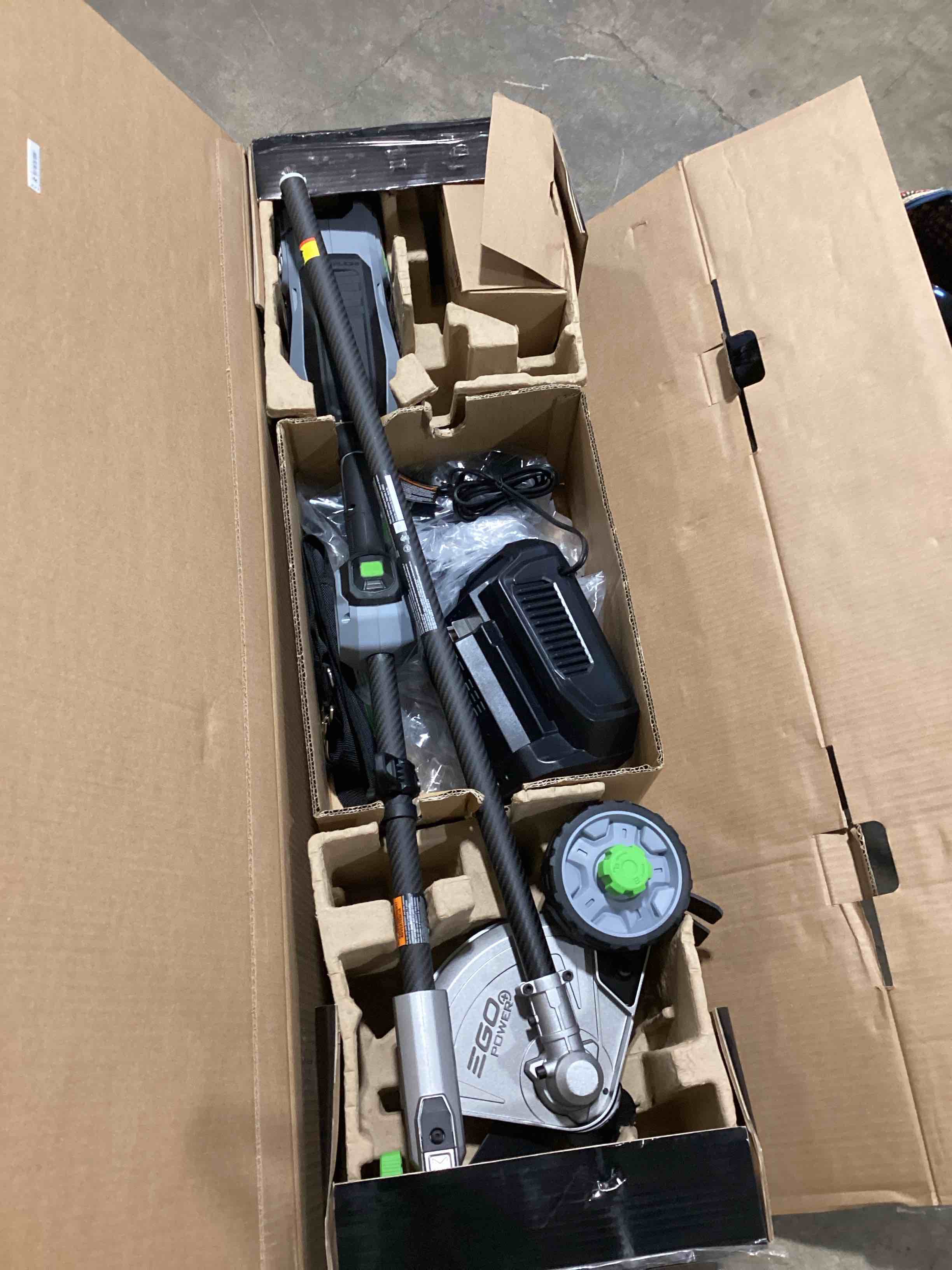 Condition photo showing As Is for ego power+ mhc1603 multi-head combo kit 16-inch 56-volt carbon fiber string trimmer with powerload & 8-inch carbon fiber edger attachment & 56-volt power head, 4.0ah battery and 320w charger included combo carbon fiber combo kit, w/4.0ah battery