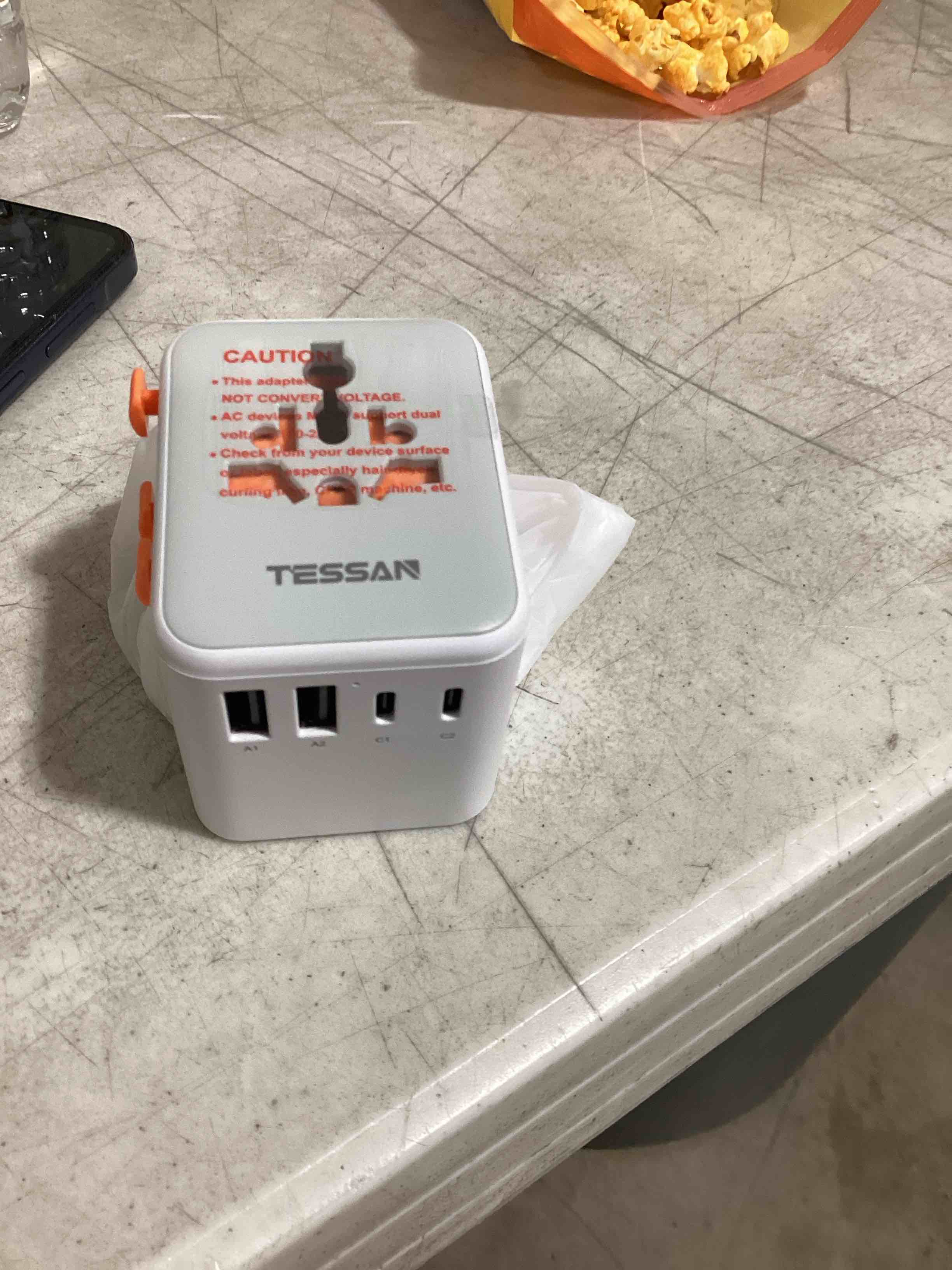 Condition photo showing As Is for tessan universal travel adapter, international power adapter with extra 2 prong ac outlet, 5 usb ports (3 usb c), 28w worldwide plug adaptor for us to europe uk australia ireland (type c g a i) white orange