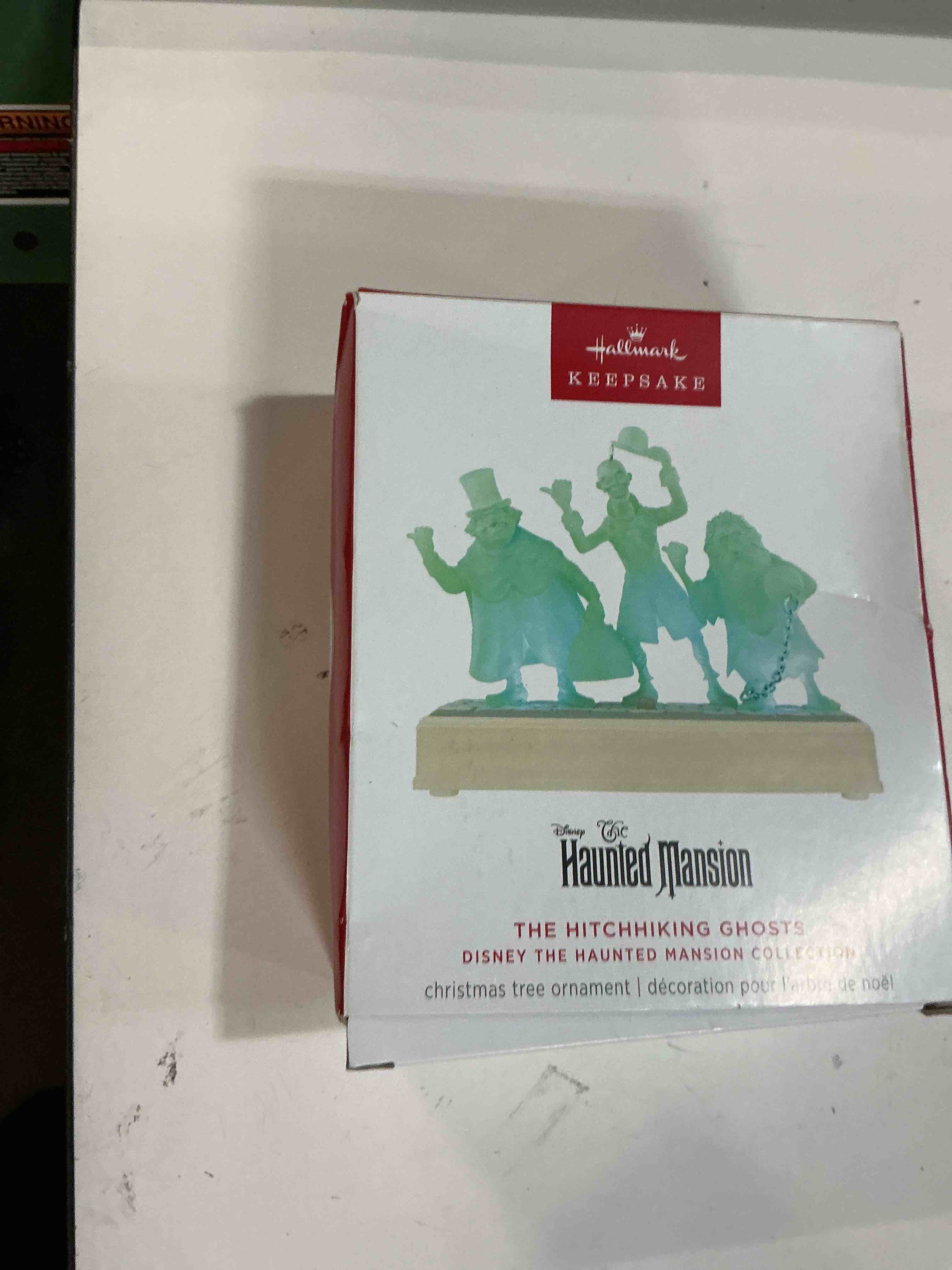 Condition photo showing New/Like New for hallmark keepsake christmas ornament, disney the haunted mansion collection the hitchhiking ghosts with light and sound