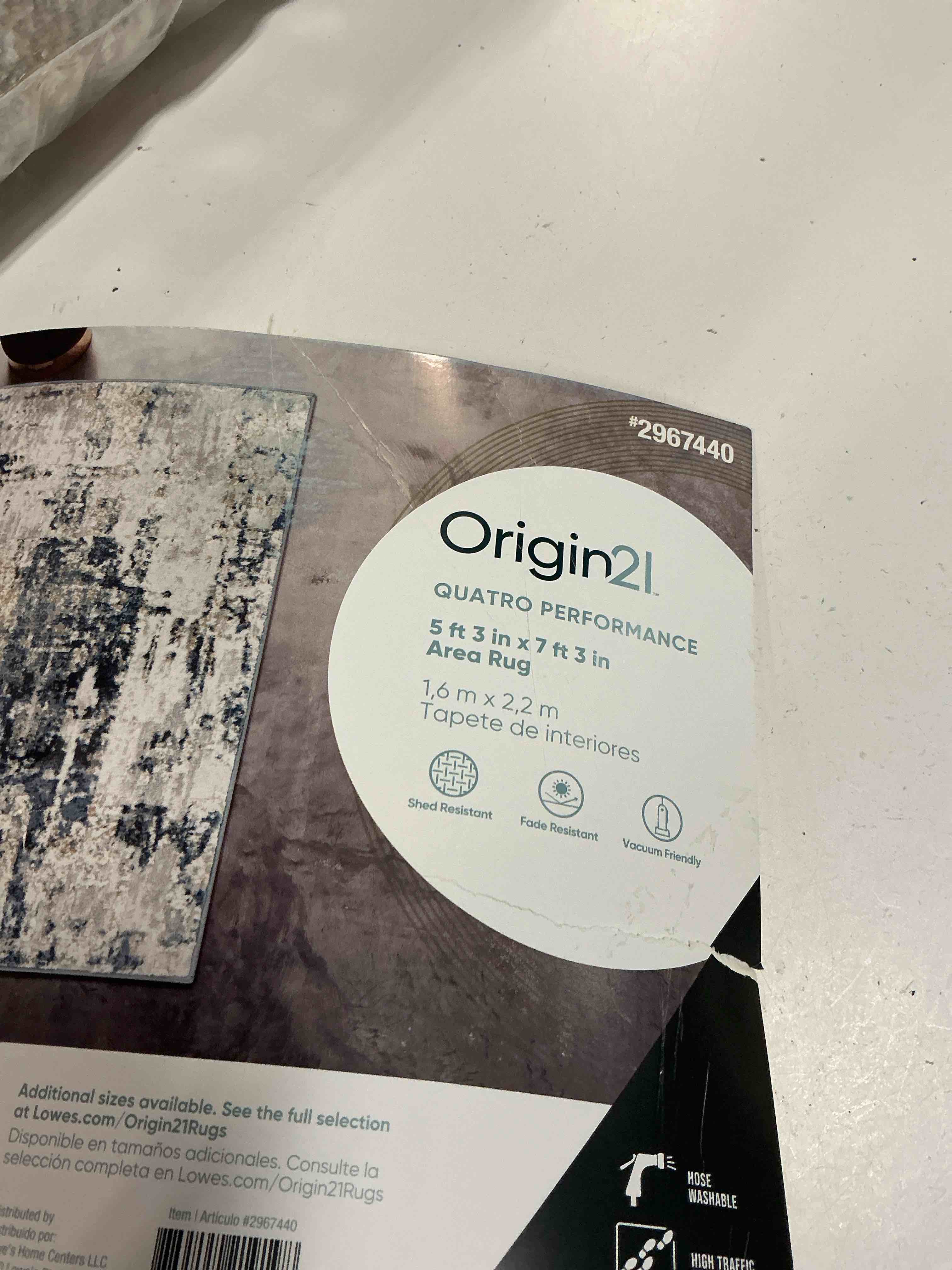 Condition photo showing As Is for origin 21 with stainmaster quatro 5 x 8 (ft) loomed polyester/polypropylene blue