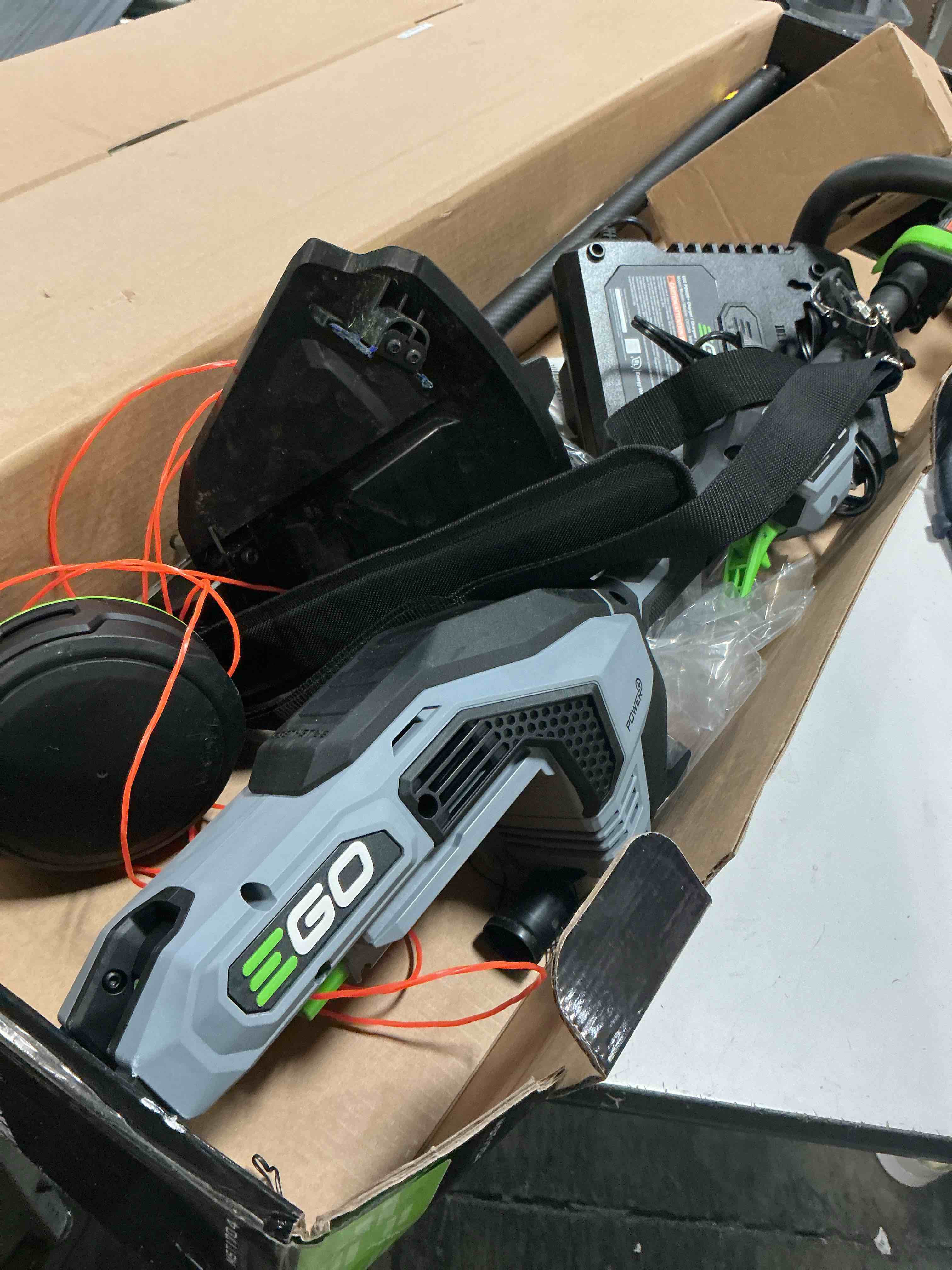 Condition photo showing As Is for ego power+ string trimmer, battery powered, 16" trimmer for weeds and grass with powerload, line iq, telescopic carbon fiber shaft, includes 56v 4.0ah battery and charger - st1623t