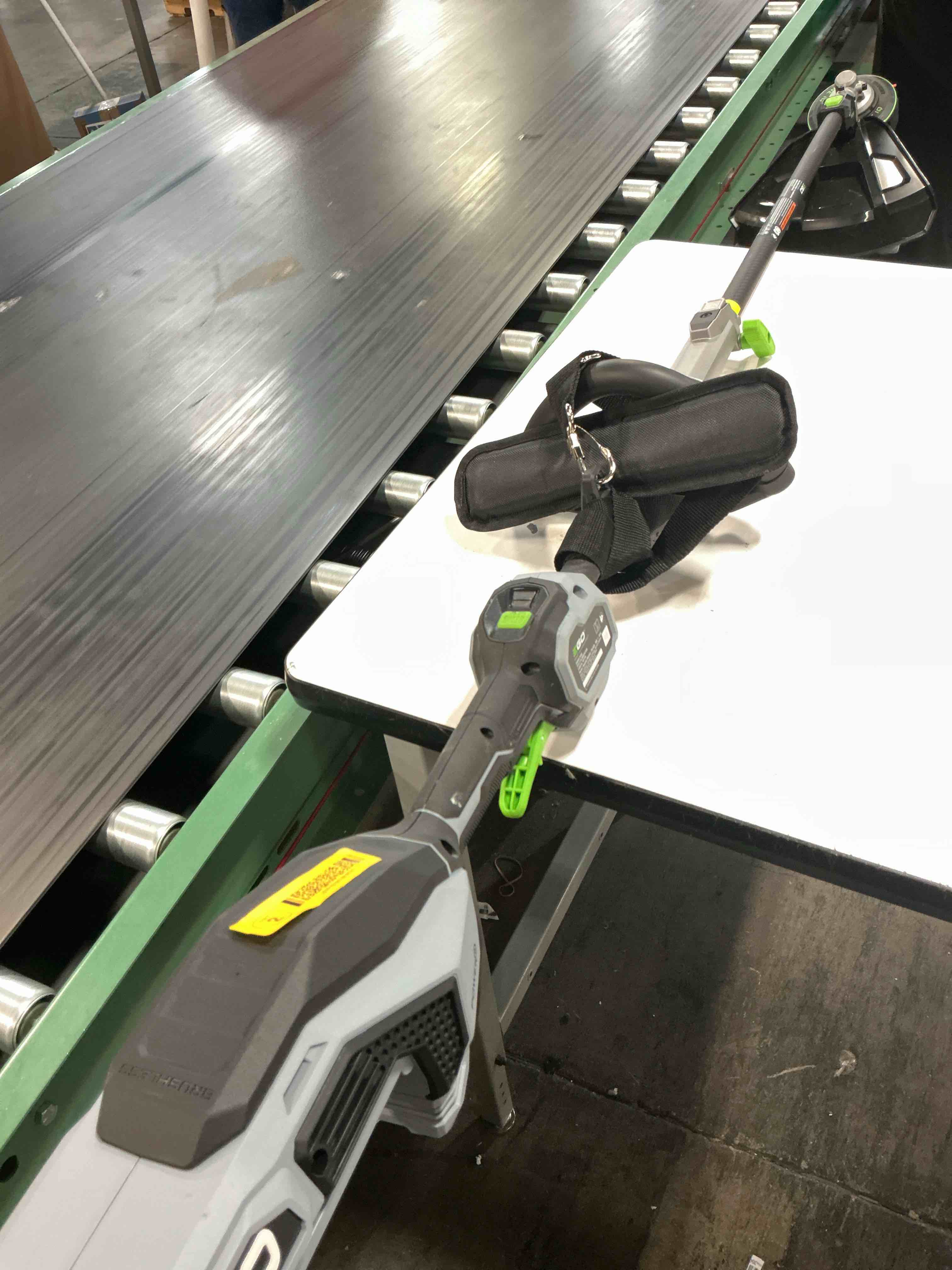 Condition photo showing As Is for ego power+ st1623t 56-volt 16-inch cordless string trimmer, 4.0ah battery, 320w charger included plus extra ba1400t 2.5ah battery
