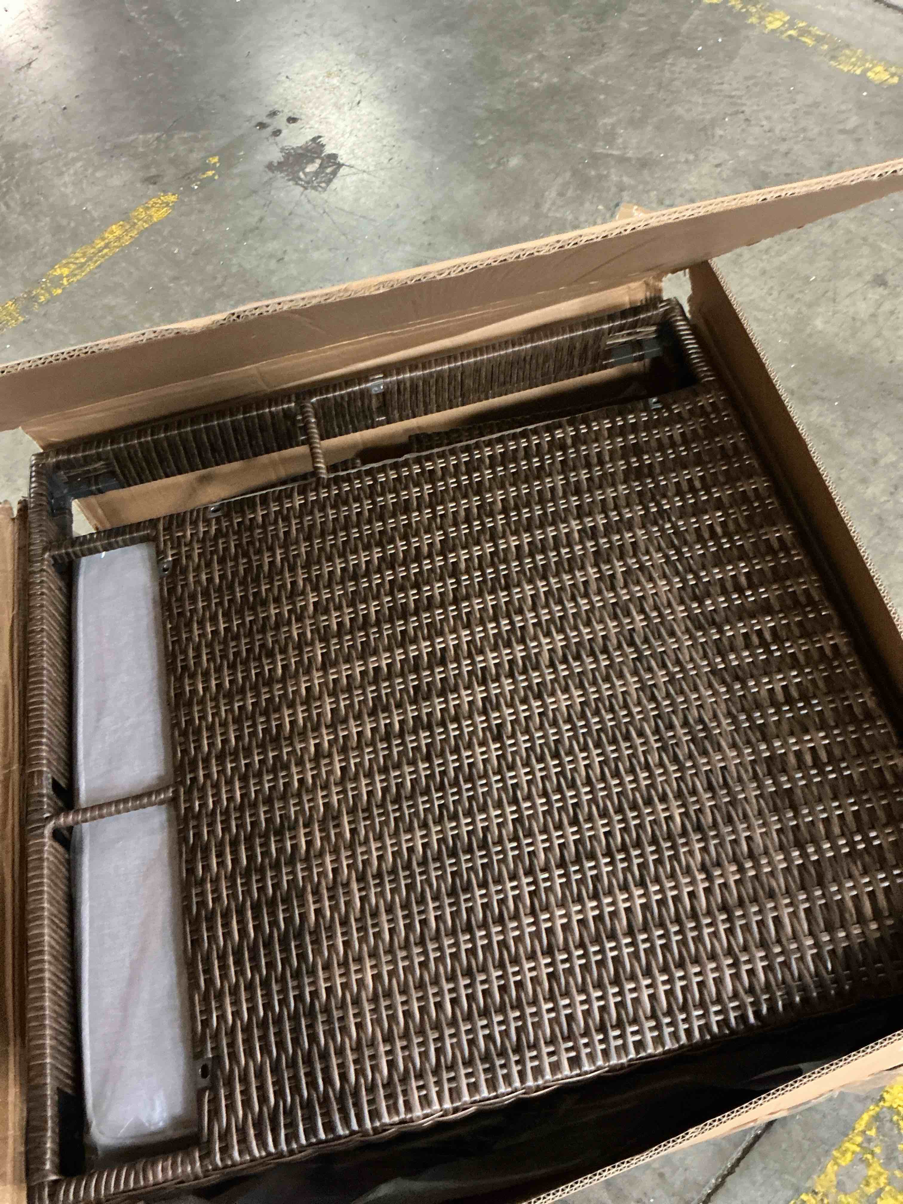 Condition photo showing As Is for brown outdoor wicker sectional with grey cushion (incomplete box a only)