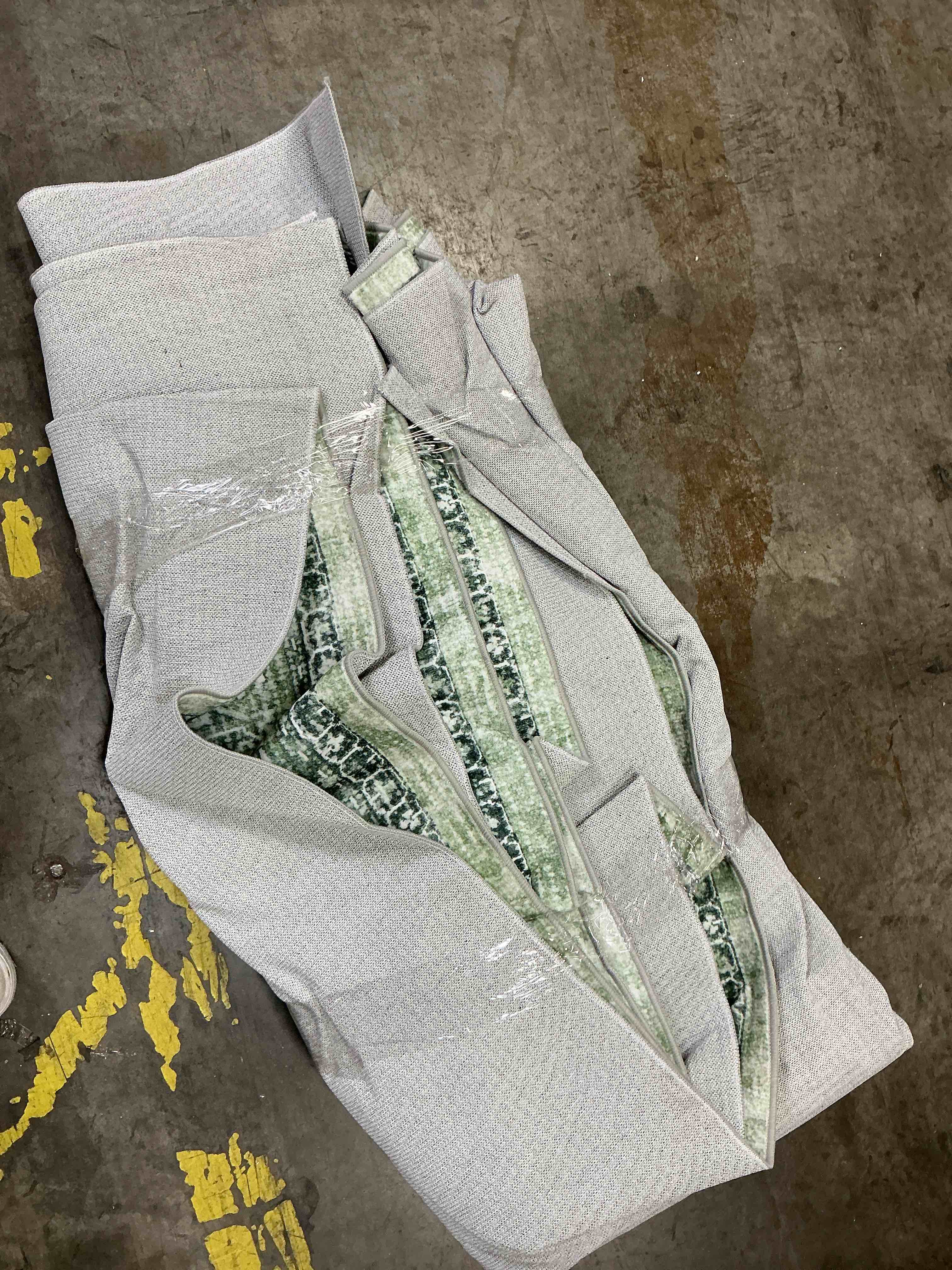 Condition photo showing As Is for green abstract area rug 