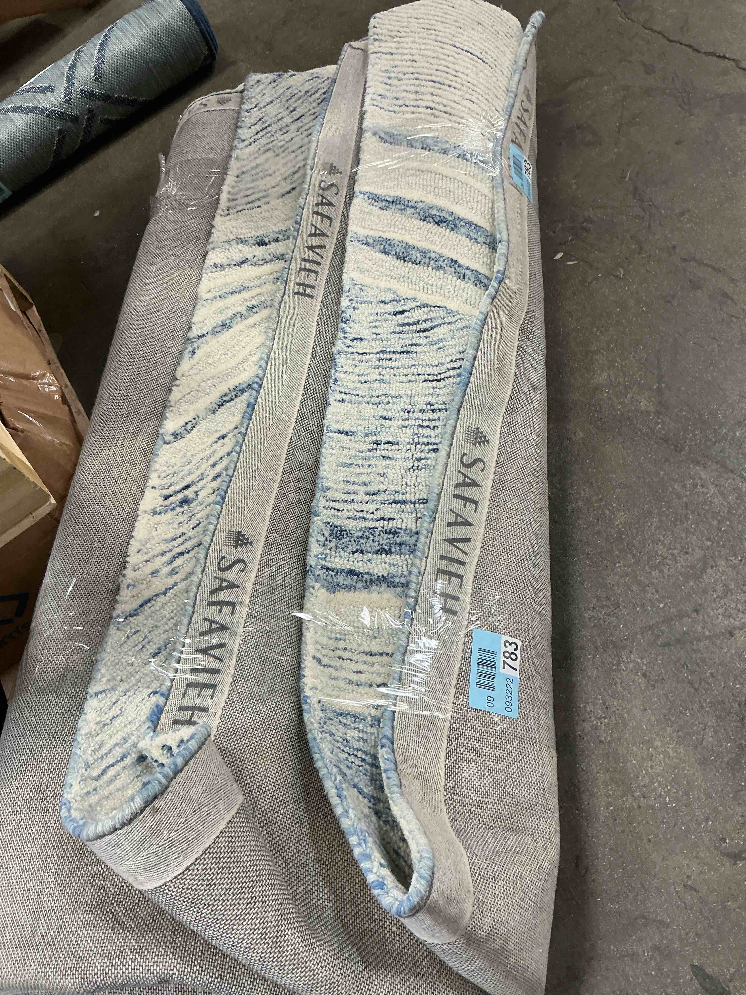 Condition photo showing As Is for safavieh white and blue abstract area rug