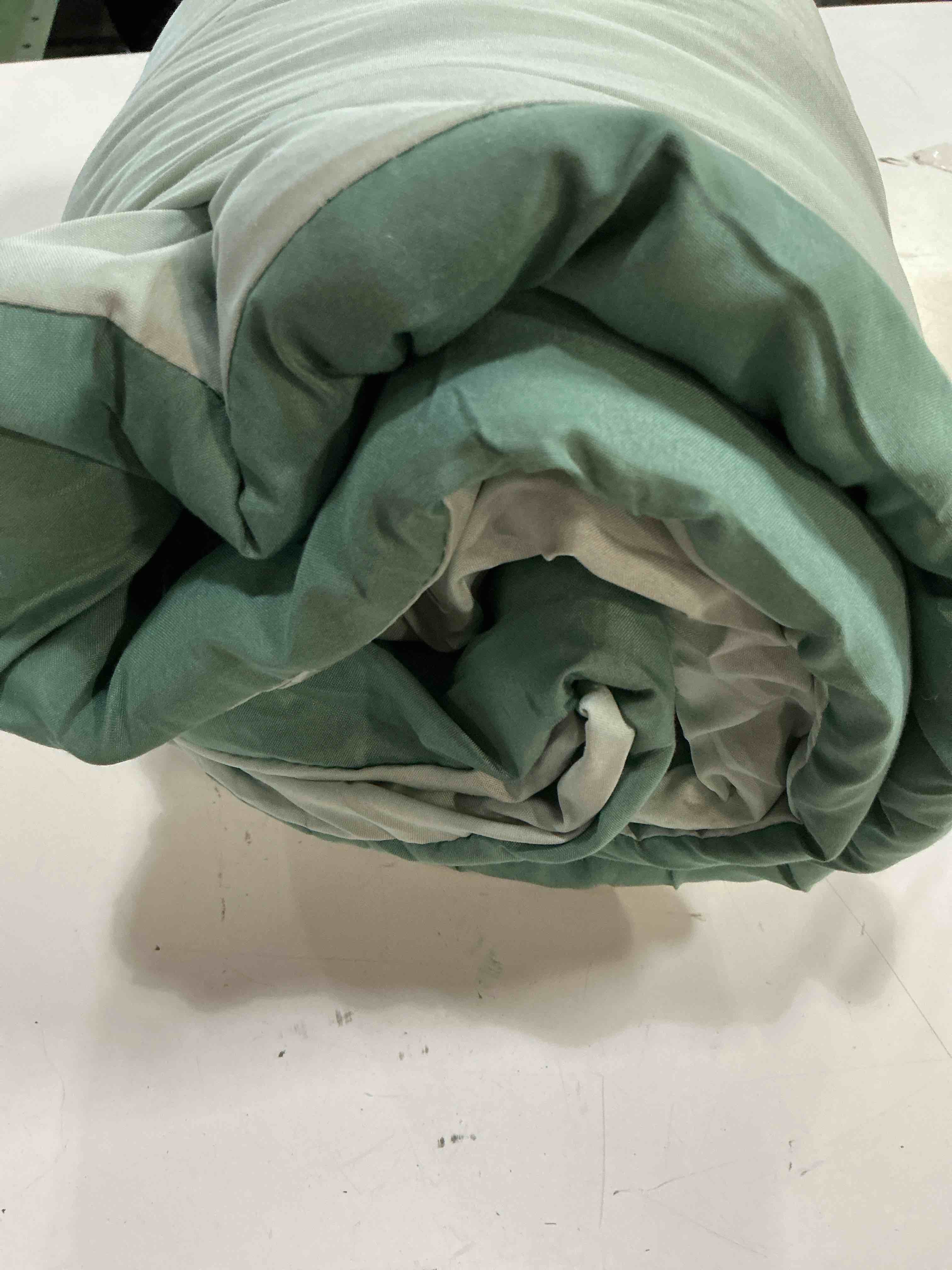 Condition photo showing As Is for reversible comforter green sage