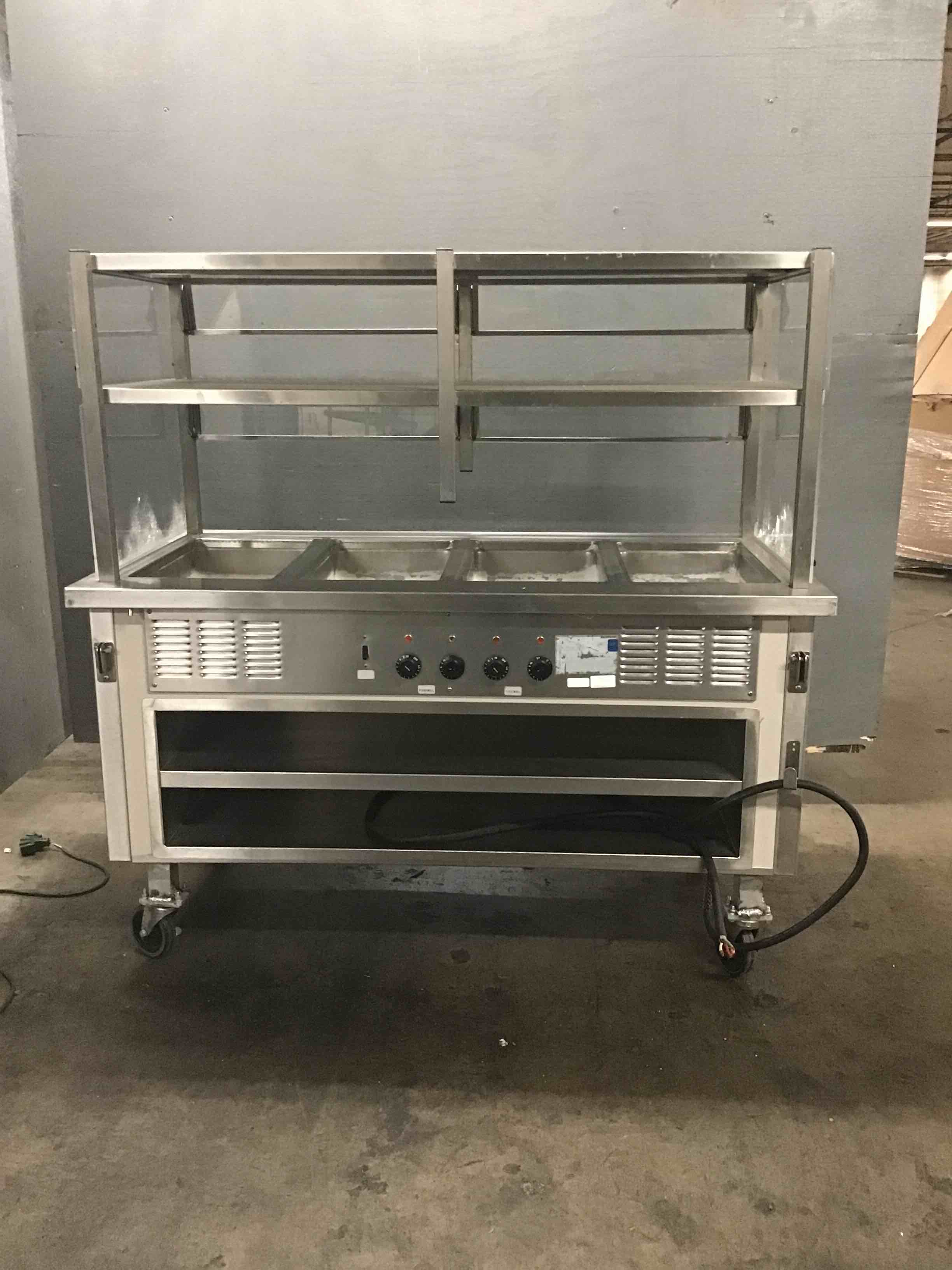 Delfield Stainless Steel 60 Inch 4 Well Steam Table With Sneeze Guard And Storage Shelf On Casters