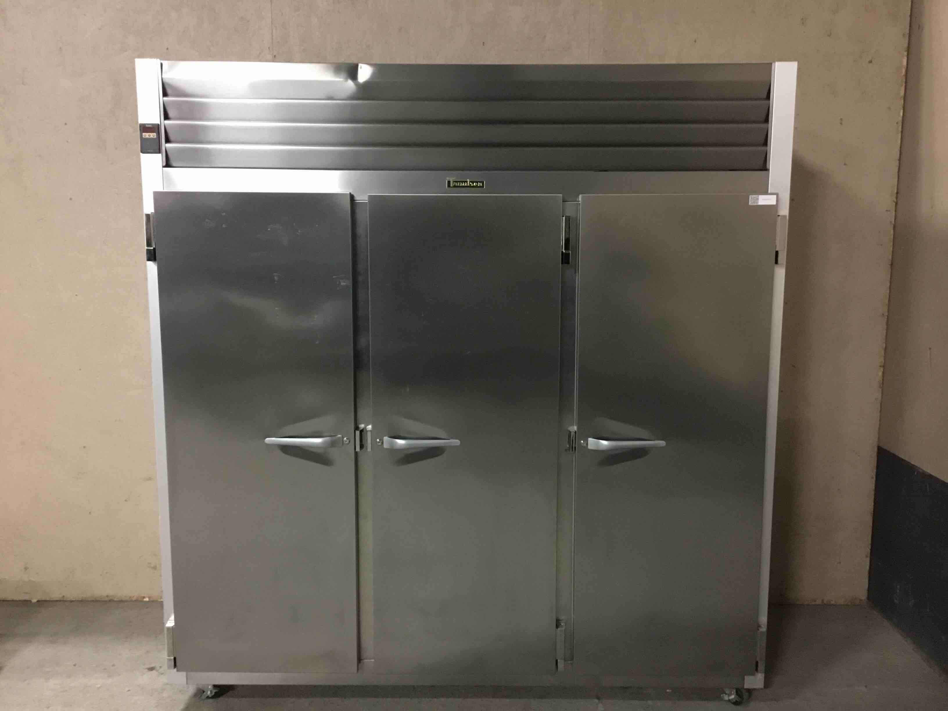 TRAULSEN 77 INCH STAINLESS STEEL 3 DOOR REACH IN FREEZER ON CASTERS 