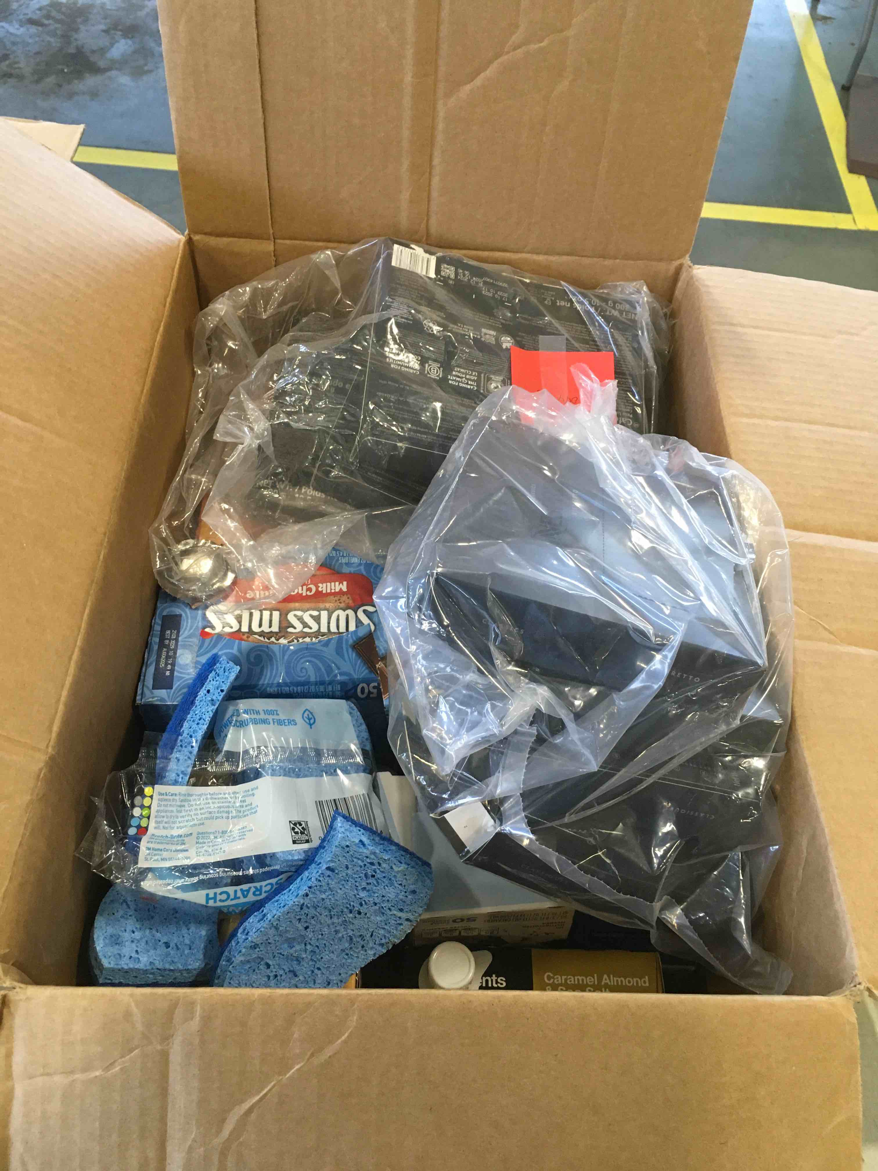 Box of assorted home supplies including, coffee, hot chocolate, fiber one bars and more 