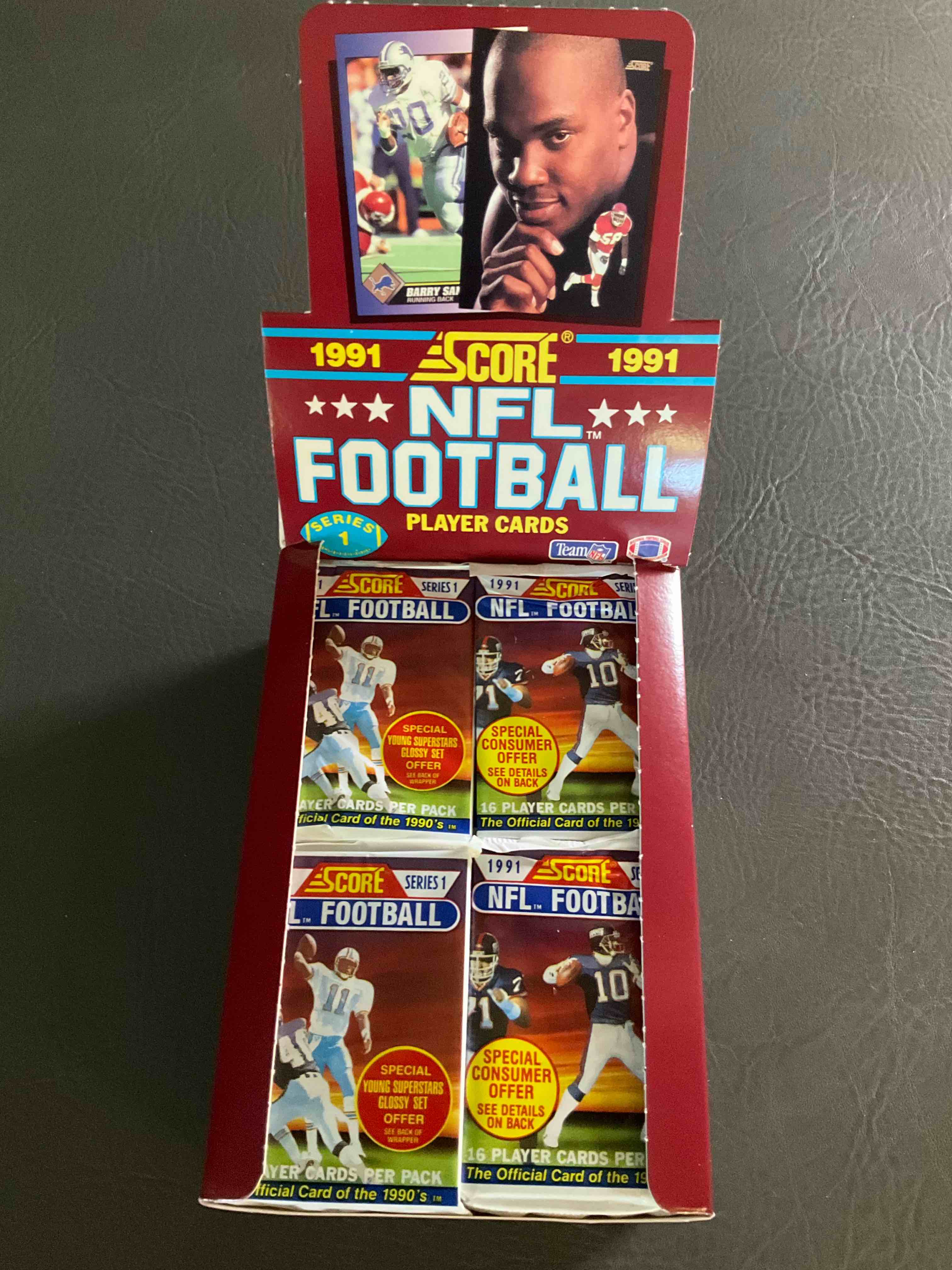 1991 NFL Score Football Sealed Card Pack, Direct From Original Retail Case! These Cards Are Sought After By Collectors For Their Awesome, Nostalgic Look. Search For Brett Favre Rookie, Early Jerry Rice, Early Emmit Smith, Joe Montana & So Much More!