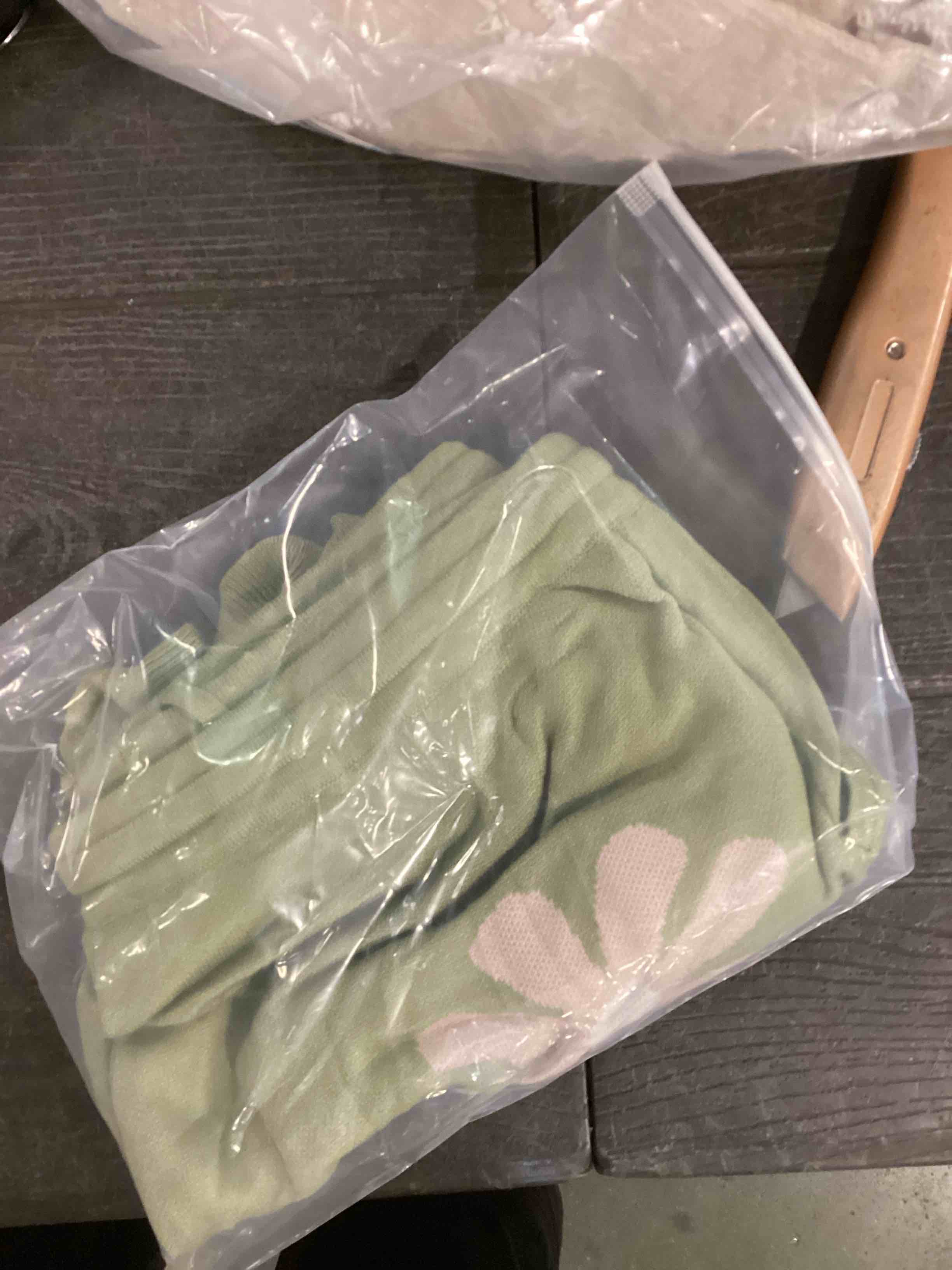 green shorts with a 2 pink flowers on them